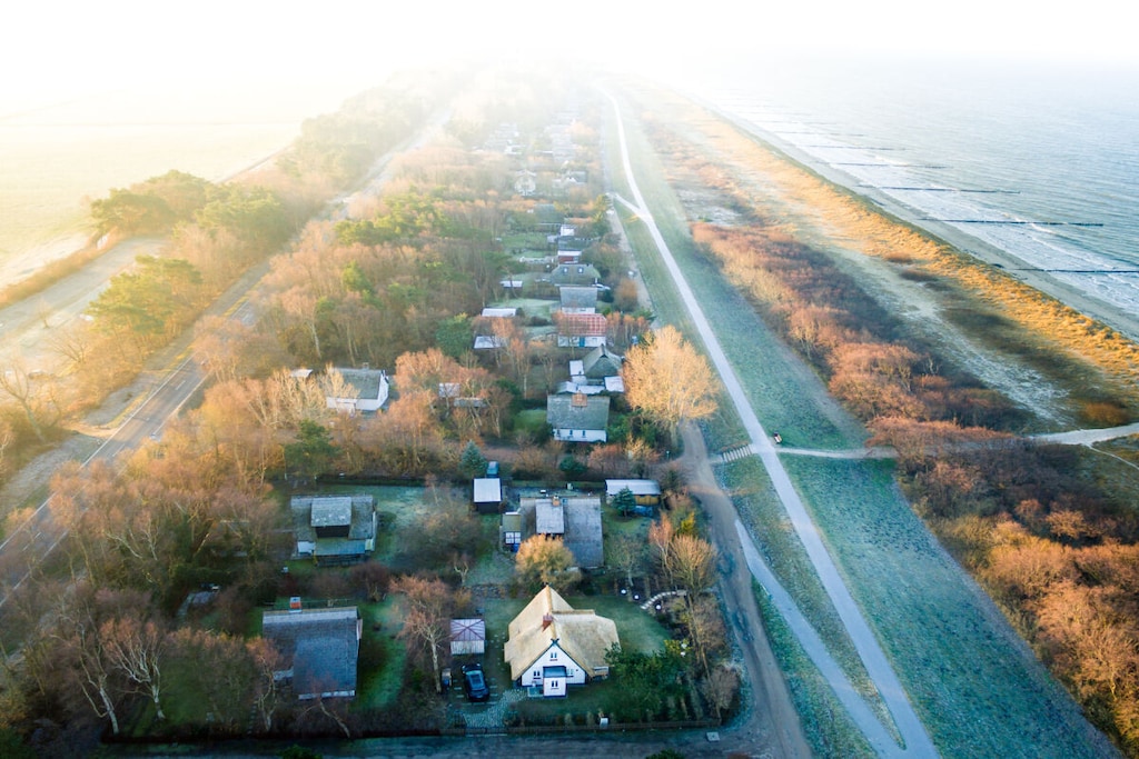 Holiday home in the Baltic Sea resort of Wustrow with exclusive furnishings, including sauna, fireplace and SUP boards in a direct beach location for quality-conscious guests.