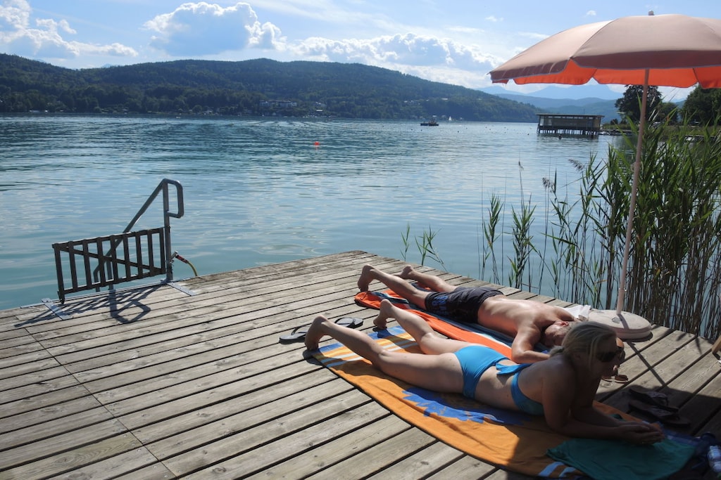 On the 2nd floor: (Living room(Armchair, Mirror, Sofa, TV, dining table), bedroom(Bed Linen, Mirror, Wardrobe, double bed), bedroom(Armchair, Bed Linen, Mirror, Wardrobe, single bed, washbasin, hairdryer), bathroom(Bed Linen, Mirror, Sofa, Wardrobe, Wardrobe Coatrack, stove, shower, washbasin, hairdryer))\n\nFire Alarm, Hot Water, Pier, Safe, Vacuum Cleaner, Kitchen(Kitchenette, dining table, hob, electric kettle, toaster, coffee machine, oven, microwave, dishwasher, fridge, freezer), guest toilet(Mirror, washbasin), Internet access, Internet access, First Aid, balcony(garden furniture, awning), heating, garden(Barbecue center, Lawn, garden furniture, sun loungers), parking, stair gate, drying cabinet, telephone