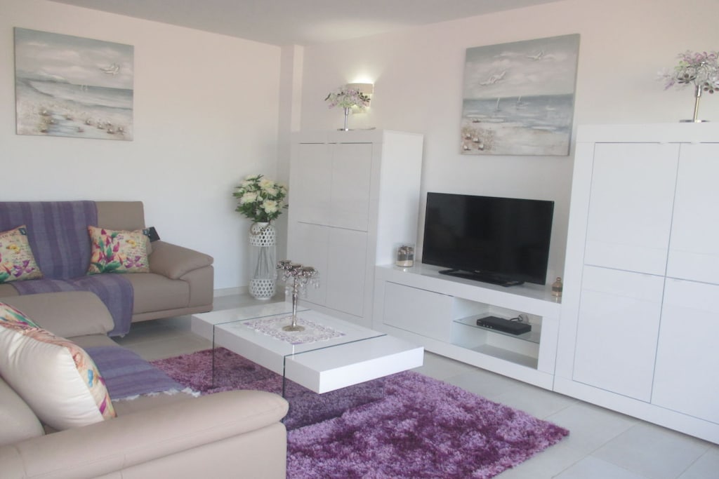 On the 2nd floor: (Kitchen(microwave), bedroom(Bed Linen, Wardrobe, Wardrobe Coatrack, double bed), bedroom(Bed Linen, Wardrobe, single bed, single bed), bathroom(Make Up Mirror, Mirror, toilet, bath tub, shower, shower, washbasin, hairdryer), lounge set(Sofa, TV, TV))\n\nHot Water, Internet Access DSL, Vacuum Cleaner, garage, Internet access, Internet access, tumble dryer, washing machine, terrace(Sun Umbrella, garden furniture, sun loungers), stair gate, ironing board, iron, drying cabinet