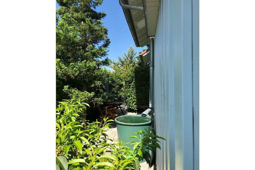 A small, comfortably furnished holiday apartment invites you to be our guest. 

The fitted kitchen, a shower room with toilet and mirrored cabinet, the living room with dining corner, 2 sofa beds opposite each other and an adjoining small terrace can be found on the ground floor. A wooden staircase leads you from the bright living room, furnished in Scandinavian style, to the 1st floor and to the gallery, which gives you a clear view of the lower living room. From here you reach the spacious bedroom, with a double bed, wardrobe and desk, where you can work, read or retreat in peace if you wish. 

The car can be parked on the street. We offer a lockable shed for your bicycles.