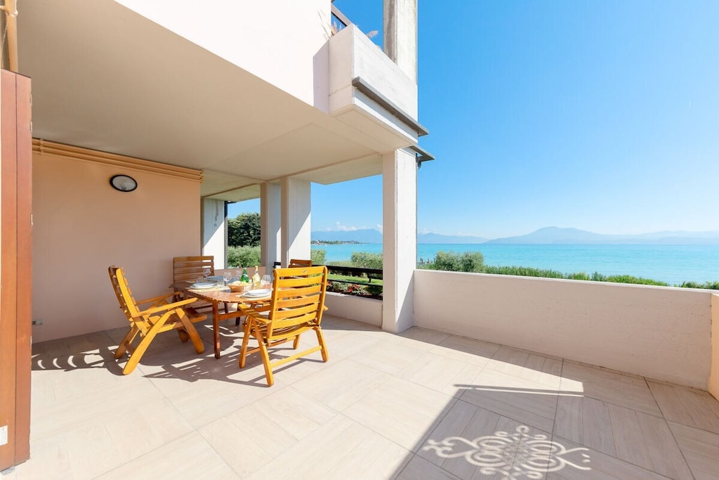 In the prestigious town of Sirmione, one bedroom apartment for a family or group holiday up to 4 people!
The apartment, equipped with Wi-Fi internet connection, welcomes guests with bright living room with sofa bed, flat screen TV, dining table with chairs, fully equipped kitchen with: gas stove, fridge, freezer, microwave, oven, kettle, citrus press, coffee machine and toaster.
The living room leads to a private terrace with table and chairs for outdoor lunches and breakfasts with a splendid view of the lake!
The apartment continues with the master bedroom with a comfortable double bed and wardrobe.
The layout of the apartment is completed by the bathroom with shower, sink, bidet and toilet.
The swimming pool of the residence is available from 01 June to 30 September.
The guests of the apartment can easily park two cars in the private garage (dimensions: 5x2.95m) and in the private parking space.
With a small additional charge, possibility of providing a cot and a child seat.