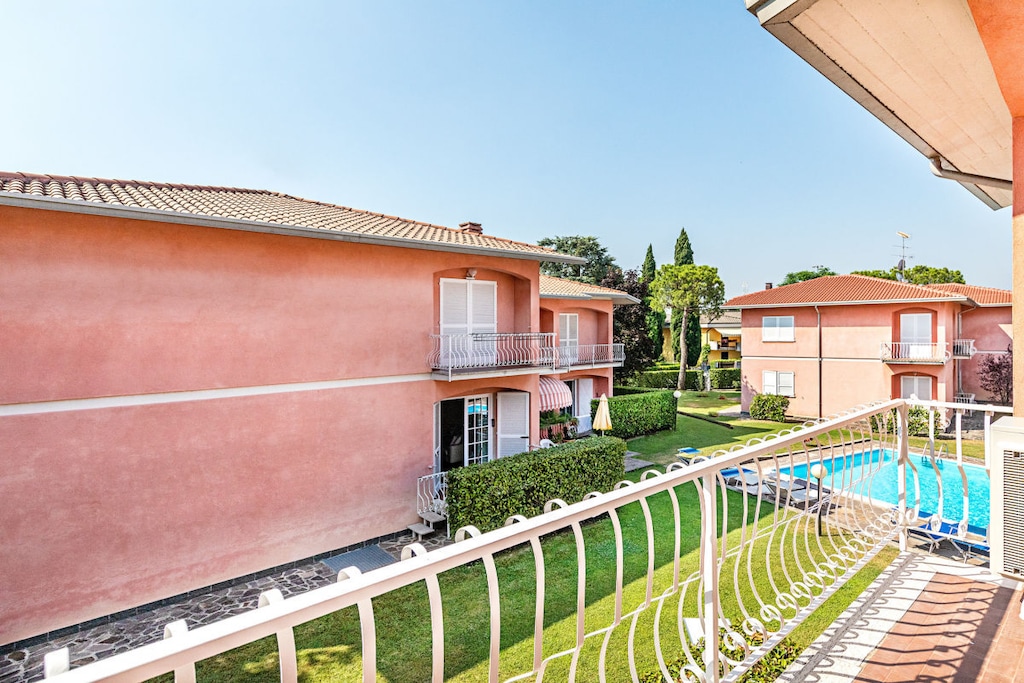 Located in the prestigious town of Sirmione, a few steps from the lake and the beach, apartment in a residence with pool with 2 bedrooms on the first floor, for a lakeside holiday for up to 6 people!

The apartment, equipped with free Wi-Fi internet connection, welcomes guests with the large and bright living room, furnished with double sofa bed, dining table with chairs, flat screen TV, fully equipped kitchen with stove, fridge, freezer, oven, microwave, dishwasher, kettle, citrus juicer, coffee machine and toaster.

From the living room you go out onto the private balcony with a small table and chairs.

The apartment, with air conditioning in all rooms, continues with the master bedroom with a comfortable double bed, closet and a private balcony overlooking the pool; the second bedroom consists of two single beds and a wardrobe.

The furnishings of this apartment are completed by the bathroom with bathtub, sink, bidet, toilet and washing machine.

The shared pool is open from April 15th to September 30th. Swimming cap is required.

Guests can conveniently park their car in the apartment's private garage.

With a small additional charge, possibility of providing a cot and a high chair for children.

Pets are not allowed.