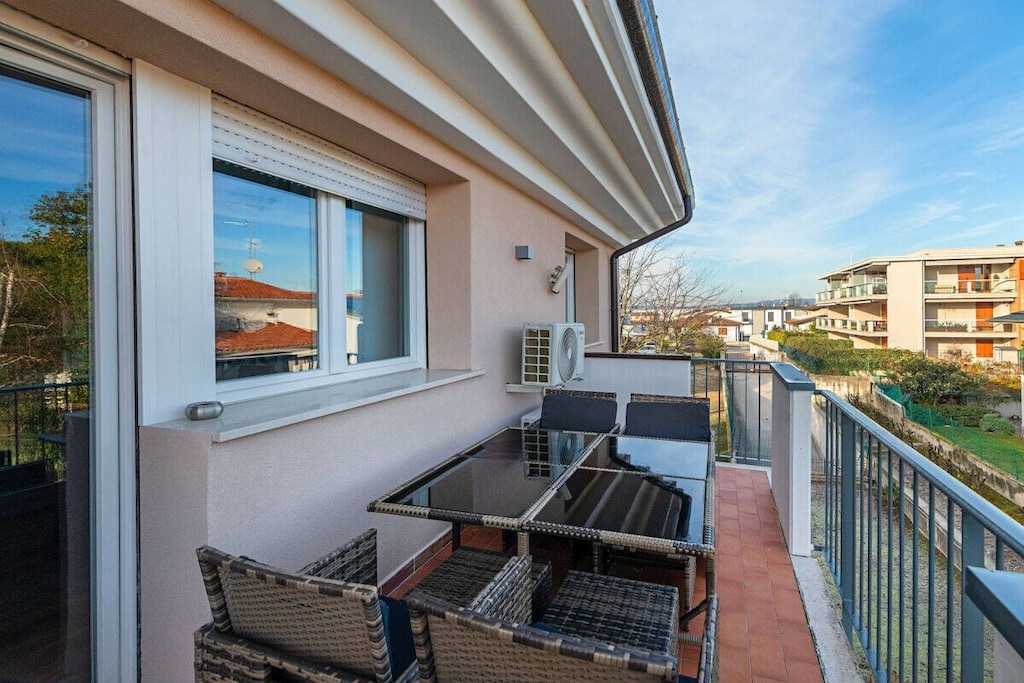 The apartment, located on the second floor, welcomes guests with a large and bright living room, furnished with a double sofa bed, flat screen TV and dining table with chairs. In the same room there is an open kitchen, well equipped and also has a dishwasher, kettle, coffee machine, juicer and toaster. Through a French window in the living room, guests have access to a private terrace overlooking the communal garden below. The master bedroom is furnished with a comfortable double bed and wardrobe and also has a window. Through an internal staircase located in the living room, it is possible to reach the attic floor. Here, thanks to a folding door, enjoys good privacy and results as a perfect relaxation zone, furnished with a comfortable double sofa bed, flat screen TV, wardrobe, table with chairs and rotating support for the computer. A full bathroom with shower and hairdryer completes the apartment.

Guests have at their disposal amenities such as air conditioning in the living room and in the bedroom, free Wi-Fi, washing machine, iron and ironing board.

*The shared pool is open from June 1st to September 30th.

All TVs are tuned to the ASTRA satellite, which allows access to German channels.

Guests can park their car in the private garage. Additional cars can be parked outside: a few meters away there is a free parking space.

*Together for a safe holiday.

*We inform our guests that renovation and painting work is currently being carried out in the facility. Therefore, construction scaffolding will be present.*