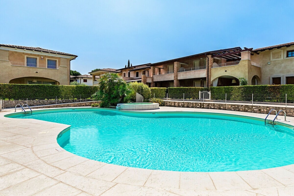 The house welcomes its guests with a large, bright and open living room, furnished with a sofa, a flat screen TV, a dining table with chairs and a well-equipped kitchen with a coffee machine, kettle and dishwasher. Through two French doors, guests access the covered veranda and the garden, also furnished with a dining table with chairs for eight people. An additional toilet completes the floor, which also contains a washing machine. On the first floor there are the sleeping quarters: the first bedroom has a double bed and a wardrobe, from which you can access the private terrace overlooking the courtyards of the residence through a French door. The second bedroom consists of a double bed and a wardrobe, also with a French door that leads to a small balcony. The third bedroom is furnished with a single bed and a wardrobe. A second bathroom with shower and hairdryer is available to guests.

The semi-basement is furnished with a double bed and an additional single sofa bed, closets and another small bathroom with shower. From here you can access the garage through a French door.

Guests also benefit from amenities such as Wi-Fi connection, air conditioning throughout the accommodation, heating and the residence's beautiful swimming pool with whirlpool.

*The shared swimming pool is open from April 1st to October 31st.

Together for a safe holiday.

This year, safety is our top priority and to guarantee your well-being, we have developed WITH, Wonderful Italy for Travel Health, our operational plan for the health of our guests and employees. We want everyone who comes into contact with Wonderful Italy to do so safely. In our homes you will experience a cozy, relaxing holiday.