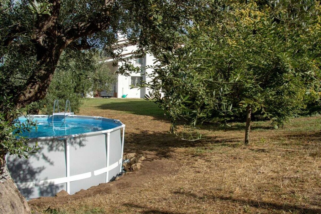 Ground floor: (Living/diningroom(Sofa, TV, dining table), bedroom(Bed Linen, Wardrobe, double bed), bedroom(Bed Linen, Wardrobe, single bed, single bed), bathroom(Mirror, toilet, bath tub, shower, washbasin, bidet, Towels incl.))\n\nHot Water, Vacuum Cleaner, Internet access, washing machine, heating, terrace(Sun Umbrella, garden furniture, sun loungers), garden(Spices, Sun Umbrella, Barbecue center, Lawn, cot, garden furniture, sun loungers, swimming pool, children\'s bed, high chair), parking, ironing board, iron, drying cabinet, Charging post for electric cars