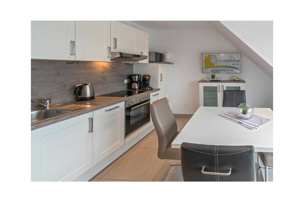 Landoase holiday apartment
The name of the holiday apartment says it all - here you will really find an enchanting country oasis. Just 100 meters from the beach, you are very close to the North Sea and can enjoy yourself in your cozy holiday home.
The Landoase holiday apartment is decorated in warm and light tones. Guests will also find everything they need for a pleasant stay. In the living room there is a comfortable couch with space for the whole family. The entertainment program is guaranteed thanks to the modern flat-screen satellite TV system, DVD and CD player.
The modern fitted kitchen contains everything you need: the built-in stove with ceramic hob, the spacious refrigerator and the filter coffee machine are obligatory, Senseo pad machine, microwave and dishwasher are a convenient additional option. Of course, there is also a washing machine available in this property.
A special highlight is the bathroom. It is not only very attractively designed, but also offers additional comfort with the level glass shower, underfloor heating and towel dryer.
Four people can feel at home in the country oasis. There is a bedroom with a large double bed and a second room with two single beds. While the double room is on the same level as the rest of the living area, the second room in the attic has a very special flair due to the sloping ceilings.
For a carefree start to your vacation, book our linen package. This consists of bed linen, towels, shower mats, tea towels and a service set (toilet paper, dishwasher tablets, garbage bags, dish brush, cleaning cloths and other little helpers for a carefree start to your vacation.