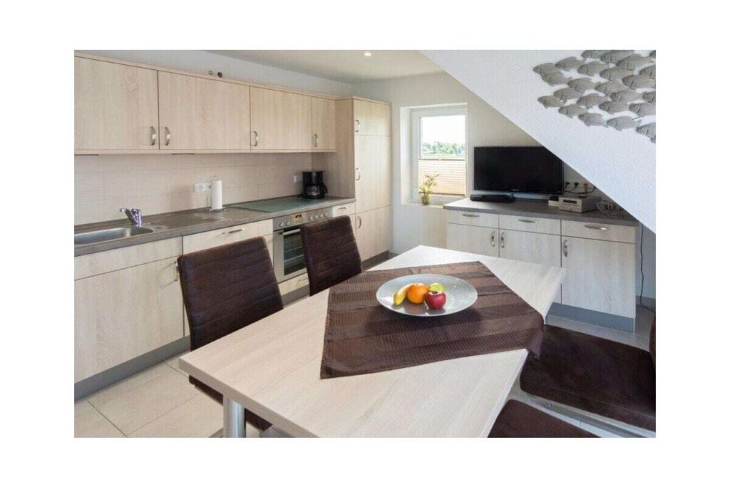 Holiday apartment Strandlilie
The cozy holiday apartment Strandlilie is ideal for a family of four. You won't miss anything here. The holiday apartment consists of a modern living and dining area with a bright, friendly atmosphere, where everyone feels at home. In the two bedrooms, guests can enjoy a pleasant night's sleep in either a double bed or two comfortable single beds. The rooms can be darkened using electric blinds so that you can enjoy undisturbed sleep well into the early hours. Otherwise, guests will find everything they need for a pleasant holiday stay here: The kitchen is equipped with all appliances such as a dishwasher, refrigerator with freezer compartment, oven, ceramic hob, filter coffee machine, waffle iron, toaster, kettle, egg cooker, Senseo coffee pad machine and blender. The living room has a modern flat screen TV including satellite TV. The bathroom offers the best comfort thanks to the floor-level modern glass shower, underfloor heating, an integrated towel dryer and an additional cosmetic mirror.
Perfect for families with a baby or toddler: The parents' bedroom is big enough to set up a baby bed. A high chair can also be provided on request.
For a carefree start to your vacation, book our linen package. This consists of bed linen, towels, shower mats, tea towels and a service set (toilet paper, dishwasher tablets, garbage bags, dish brush, cleaning cloth and other small helpers) for a carefree start to your vacation.