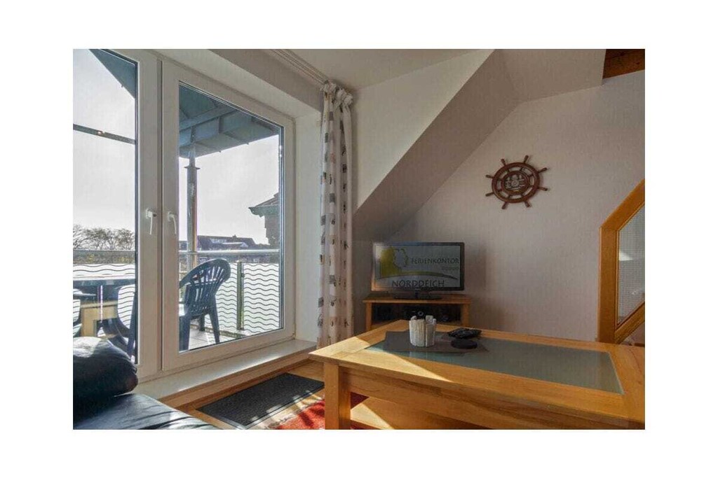 Holiday apartment Nörddiek
Holiday apartment Nörddiek exudes great coziness due to its lovingly put together furnishings. A family of four will find all the comfort they need here. The large living area including TV, satellite TV, DVD and CD player invites you to spend sociable evenings. The special thing about this apartment is definitely the wonderful view of the North Sea, which you can enjoy from the upper floor.
In the large kitchen-living room you will find everything you need for a pleasant stay. In addition to the cooking utensils, there is a dishwasher, a filter coffee machine, toaster, egg cooker and kettle.
The Nörddiek apartment has two bedrooms. The first, including a double bed, is on the same floor as the living area. The second bedroom is on the open gallery. Families with a baby or toddler have more than just a baby travel bed at their disposal. The children's crockery available also testifies to the child-friendliness of this holiday apartment.
The holiday apartment also has a storage room, in which, among other things, utensils such as a vacuum cleaner, dustpan & broom and clothes rack with clothespins are available. In the communal basement you also have the option of using the washing machine and dryer for a fee. Here you will also find an iron and an ironing board.
For a carefree start to your vacation, book our laundry package. This consists of bed linen, towels, shower mats, tea towels and a service set (toilet paper, dishwasher tablets, garbage bags, dish brush, cleaning cloths and other small helpers) for a carefree start to your vacation.