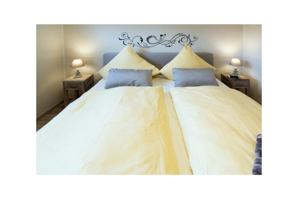 Holiday apartment Jolle D11
Jolle D11 is your little holiday paradise in Norddeich. Two people will find everything they need for a pleasant stay in the comfortable and comfortably furnished apartment. The cozy seating area in the spacious living area invites you to linger. A modern flat screen TV including satellite TV, DVD player and the music system provide the desired entertainment. Bright, warm colors and many lovingly selected maritime accessories dominate this living area, so that you feel completely at home from the very first moment. The bathroom was completely renovated at the beginning of 2022 and now shines in a new light.
The chic fitted kitchen is perfectly equipped so that no culinary wishes are left unfulfilled for cozy evenings for two. In addition to the usual cooking utensils and kitchen appliances, you also have a microwave and of course a dishwasher at your disposal.
A comfortable box spring bed awaits you in the bedroom, so you don't have to worry about your restful sleep.
What is particularly nice about this property is the fully equipped terrace with a small garden, which completes your little kingdom. Spend carefree and relaxing hours here. 
For a carefree start to your vacation, book our linen package. This consists of bed linen, towels, shower mats, tea towels and a service set (toilet paper, dishwasher tablets, garbage bags, dish brush, cleaning cloth and other small helpers) for a carefree start to your vacation.