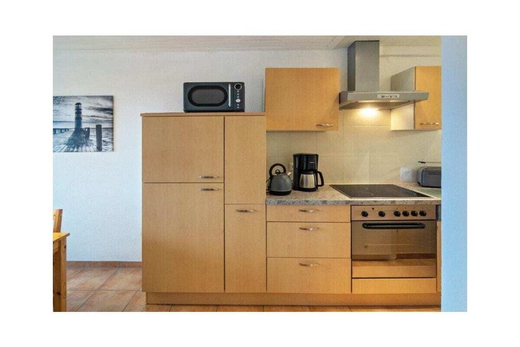 Ground floor: (hallway, Living room(single sofa bed, TV, heating), Kitchen(hob, electric kettle, toaster, coffee machine, oven, microwave, dishwasher, fridge, freezer, high chair), bedroom(children\'s bed), bathroom(shower, toilet, hairdryer))\n\nbalcony