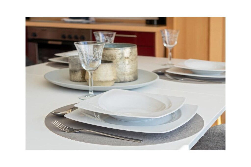 The house
In this quiet side street of Norddeich, the holiday apartment is spread over 2 floors on the upper floor in the middle house. You park your car in the parking lot in front of the apartment building. If you arrive by train, you have direct access to the Norddeich city platform. The train only travels through here at walking pace, so there is no noise.
Living room
The combined living, dining and kitchen area offers space for cooking, eating and living.
You can spend your cozy TV evenings on the couch with table and armchair.
The room also offers modern furniture with a wooden look, lots of light and a beautiful view
of the Frisia pond.
The balcony, which faces southeast, is adjacent to the living room.
Get an overview in the 360-degree panoramic view.
Kitchen
The red kitchen is compact and functional. The equipment includes: stove with oven,
coffee machine, refrigerator, microwave, dishwasher in the kitchenette, toaster,
crockery, glasses, mugs, etc. The kitchenette with dining table and 4 chairs is in the
combined living-kitchen area.
Bedroom 1
The bedroom is in the basement of the apartment, has a 180 x 200 cm double bed with
slatted frames. A closet offers space for your wardrobe. A small TV, a
valet stand and a chest of drawers complete the furnishings.
Bedroom 2
The bedroom is on the upper floor of the apartment, has a 160 x 200 cm double bed with
slatted frames and can be reached via a comfortable staircase. A chest of drawers offers space for
your wardrobe. A small TV and a compact children's bed complete the furnishings.
The stairs can be secured with a children's stair gate. The Velux window is darkened with a roller blind.
Bathroom
The bathroom has a floor-level corner shower, toilet and a washbasin combination
with mirror. A shower stool and a hairdryer are provided.
Outdoor area
On summer days, enjoy a sunny spot on the balcony facing southeast