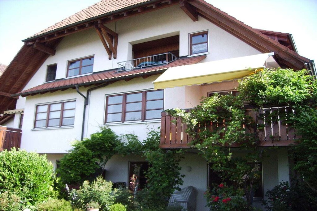 The apartment has a cozy living room with kitchenette and dining area on the 1st floor, a bright bathroom with window, shower and toilet and a smaller room for a third person. From the living room you can reach the bedroom via a comfortable staircase. 
On the covered loggia you will feel comfortable in any weather and enjoy the view of the city and the Alps.
In just a few steps you are in the old town with shops and restaurants. There is space for your car and bicycles in the carport.