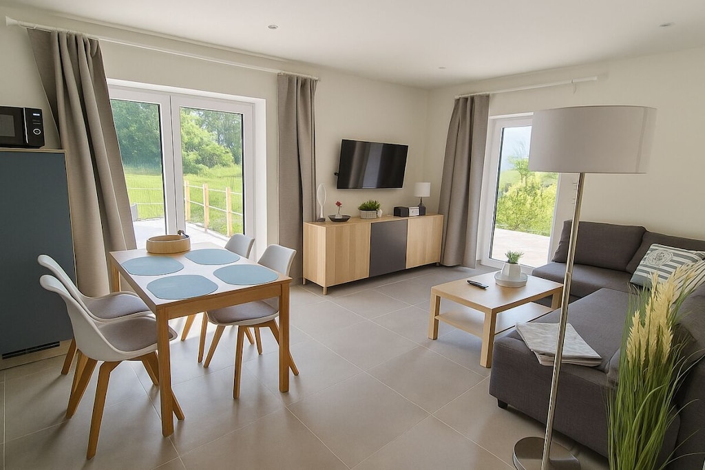 Ground floor: (bedroom(Bed Linen, Wardrobe, double bed, heating), bathroom(Mirror, toilet, shower, washbasin, heating))\n\nFire Alarm, Hot Water, Vacuum Cleaner, Living/diningroom(Sofa, TV, TV, dining table, heating), Internet access, First Aid, terrace(Sun Umbrella, garden furniture), parking, drying cabinet, Charging post for electric cars