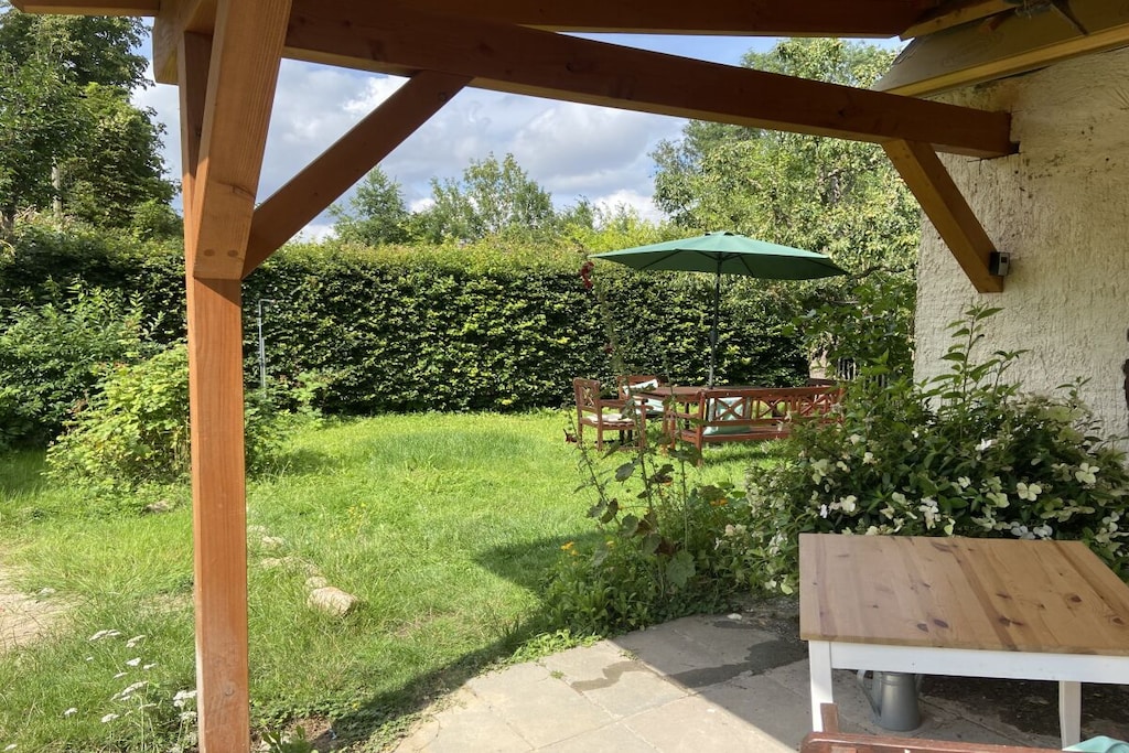 Welcome to Little Green Basedow – a lovingly furnished, newly renovated holiday apartment on two floors, located directly adjacent to the castle park on the quiet outskirts of Basedow in the Mecklenburg Lake District/Mecklenburg Switzerland region.

On the ground floor, you'll find a spacious eat-in kitchen with a wood-burning stove, a cozy dining area, and a fully equipped kitchen with a dishwasher, stove, coffee maker, and more.

The converted attic can accommodate up to six people (more than four upon request): a bedroom with a double bed and a sofa bed, another room with a bunk bed, and a modern bathroom.

A covered terrace and a garden with seating and a parasol invite you to relax outdoors.