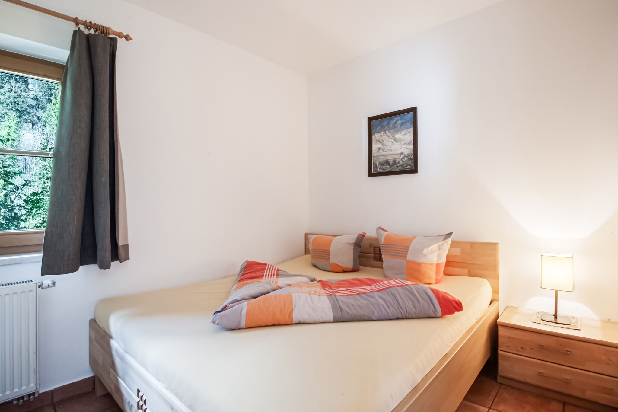 This cozy ground-floor apartment offers a comfortable retreat for up to 6 guests. The spacious living room features a double sofa bed, perfect for extra sleeping arrangements, along with a satellite TV for entertainment. The open kitchen is equipped with an oven and all necessary appliances to prepare delicious meals. The apartment includes two inviting double bedrooms, ideal for a restful night's sleep. The modern bathroom features a shower, washbasin, and toilet for your convenience.

Located in a prime spot, this apartment is close to all the attractions that make the area special. Explore nearby hiking and skiing trails, or visit local shops, restaurants, and cafes. Whether you're here for outdoor adventures or simply to relax, this apartment offers the perfect base for your stay.

Step outside onto the balcony to enjoy the fresh air and scenic views. The apartment also offers central heating, ensuring warmth and comfort during your stay. A designated parking space is available, providing hassle-free access to the property.
