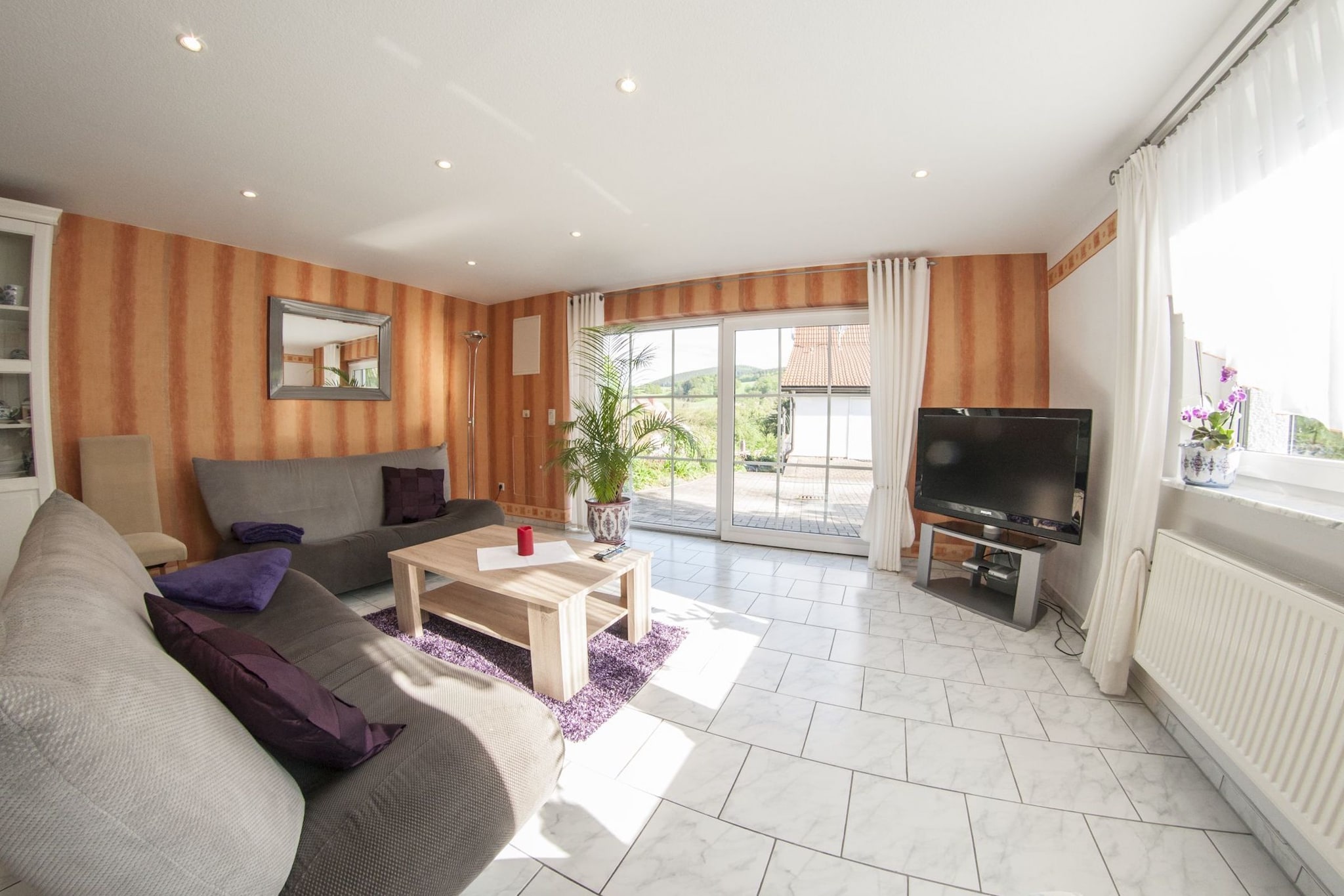 Comfortable Family Retreat
Set at the edge of the ThÃ¼ringer Forest, this inviting two-bedroom holiday home blends modern comfort with nature just outside your door. Designed to accommodate up to four guests, itâ€™s an ideal setting for families thanks to its thoughtful detailsâ€”childrenâ€™s toys, a high chair, and a safe layout. The bright living area, well-equipped kitchen, and spacious bedrooms ensure you feel at ease throughout your stay.

Nature and Activities
Located only 400 m from the town center and 2 km from public transport, the apartment makes exploring simple. Outdoor enthusiasts can venture onto the renowned Rennsteig trail, enjoy horse riding, or test the local tennis courts. In winter, nearby slopes offer skiing opportunities for all skill levels. For day trips, cultural highlights such as Eisenach, Weimar, and Gotha are all within reach, making it a convenient base for sightseeing as well as relaxation.

Relaxed Outdoor Living
Step onto your private terrace and take in the peaceful garden views, or light up the barbecue for a cozy evening meal under the sky. The shared garden provides space to unwind, with seating and play equipment for younger guests. With parking on-site and the motorway just 6 km away, arrival and departure are hassle-free. Restaurants nearby serve authentic Thuringian cuisine, adding local flavor to your holida