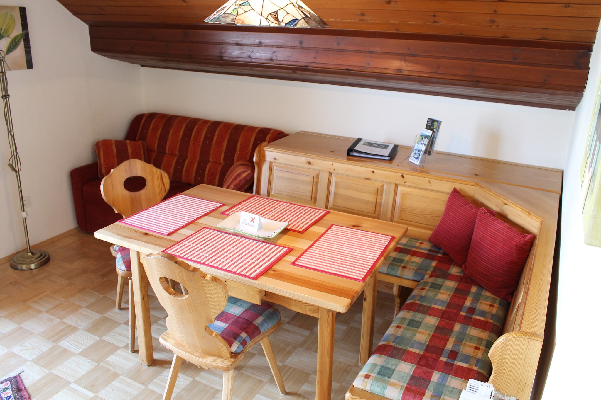 On the 1st floor: (hallway, Living room(TV, seating area, radio), open kitchen(cooker(ceramic), oven, microwave, dishwasher, fridge-freezer), bedroom(single bed, double bed), bedroom(double bed), bathroom(bathtub with shower, washbasin, toilet), balcony)\n\nBasement: (recreation room(table tennis table), relaxation area(shower, sauna), ski storage(ski boot heaters), tumble dryer(paid), washing machine(paid))\n\ngarden furniture, parking