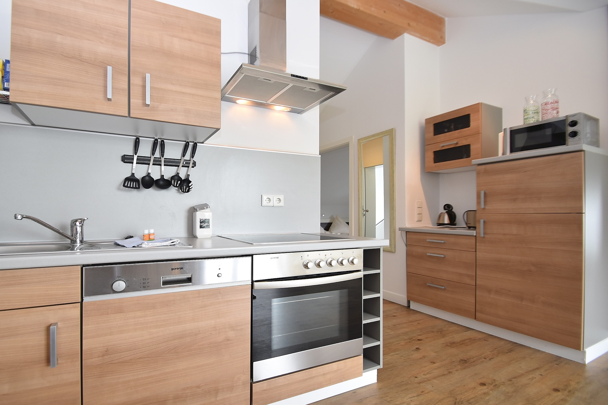 Ground floor: (hall, open kitchen(dining table, electric kettle, toaster, cooker(ceramic), hood, coffee machine, oven, microwave, dishwasher, fridge(+ freezer)), Living/diningroom(TV(flatscreen), stereo unit), bedroom(double bed(180 x 200 cm)), bedroom(2x single bed(90 x 200 cm), single loft bed(90 x 200 cm)), bathroom(shower(walk-in shower), washbasin, toilet))\n\nstorage, balcony, heating, garden furniture, parking, Sunscreen