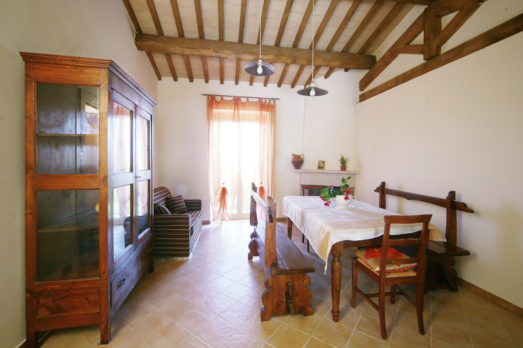 This agriturismo is nestled in Lazio, on the border of Tuscany and Umbria, perched on a hill near the ancient Via Francigena pilgrim road. The farmhouse is composed of five restored rustic houses, each offering several charming apartments. It boasts stunning views of Lake Bolsena, Montefiascone, and the surrounding countryside, making it a peaceful and picturesque getaway. The apartments feature traditional wooden beams, terracotta floors, and rustic furniture, providing an authentic, cozy atmosphere.
The region, known as Tuscia, is rich in history and natural beauty, named after the ancient Etruscan civilization that once inhabited Lazio, Tuscany, and Umbria. Nearby, you'll find numerous natural parks and archaeological sites to explore. Additionally, the largest volcanic lake in Europe, Lake Bolsena, is just a short distance away, offering even more opportunities for sightseeing and relaxation.
Guests can enjoy a communal garden with a swimming pool and a terrace that offers panoramic views of the landscape. For relaxation, there is a wellness room with a Jacuzzi, with costs arranged on-site.