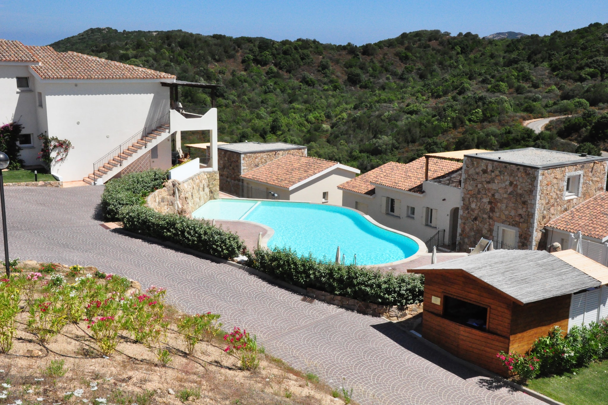 This elegant holiday home in Baja Sardinia has 2 bedrooms and can house 6 people. It is close to sea and beaches.  Ideal for a relaxing holiday with family or friends, it features a shared swimming pool and shared garden, where you can relax and refresh. 



Enjoy the sandy beaches just 1.3 km away. You can also play a game of golf, 11 km ahead at the golf course. The nearest restaurant is 3 km away. The town centre of Baia sardinia, lies 6 km away.



Enjoy cooling off in the shared swimming pool amidst quiet surroundings. There is a garden, shared with other guests, where you can laze. The air-conditioned home features an open kitchen and a living room, where you can lounge. There is a balcony, from where you can enjoy views while having cuppa. Max. 1 pet is allowed for Â€ 30/Stay. Cot and high chair is available for a small fee.
