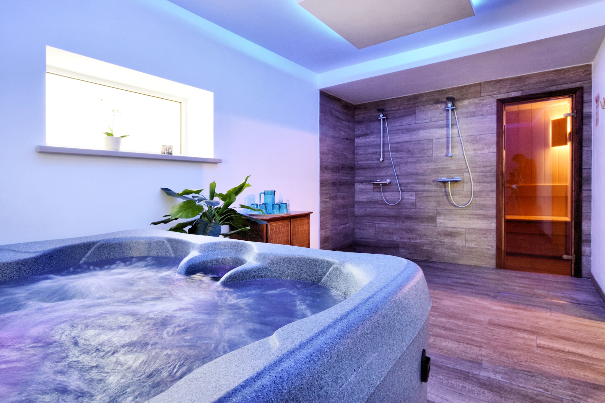 This cozy villa in Masbourg, Belgium offers a relaxing stay in the heart of the Ardennes, ideal for families or groups. Located just 500 meters from the village center and surrounded by forest and river landscapes, it’s perfect for nature walks and cycling. Nearby attractions include the Grottes de Han, the Château de Lavaux-Sainte-Anne, and the Euro Space Center, each offering a mix of adventure, history, and science. The Wallonia Rural Life Museum and Fourneau Saint-Michel are also worth visiting for cultural insights.

The home features four bedrooms across two floors, including a bunk bed and children’s bed for younger guests. The open kitchen is fully equipped with modern appliances, and the living/dining room includes a wood stove, flat-screen TV with international channels, and a DVD player. The basement houses a recreation room with air hockey, billiards, and a game console, plus a wellness area with a bubble bath and sauna. Outdoors, enjoy a patio, garden, barbecue, and games like table tennis and boules.

Dining options nearby include Le Jardin des Senteurs in Nassogne for modern cuisine, Restaurant Les 7 Fontaines D'Awenne for regional flavors, and Brasserie Saint-Monon for local craft beers.