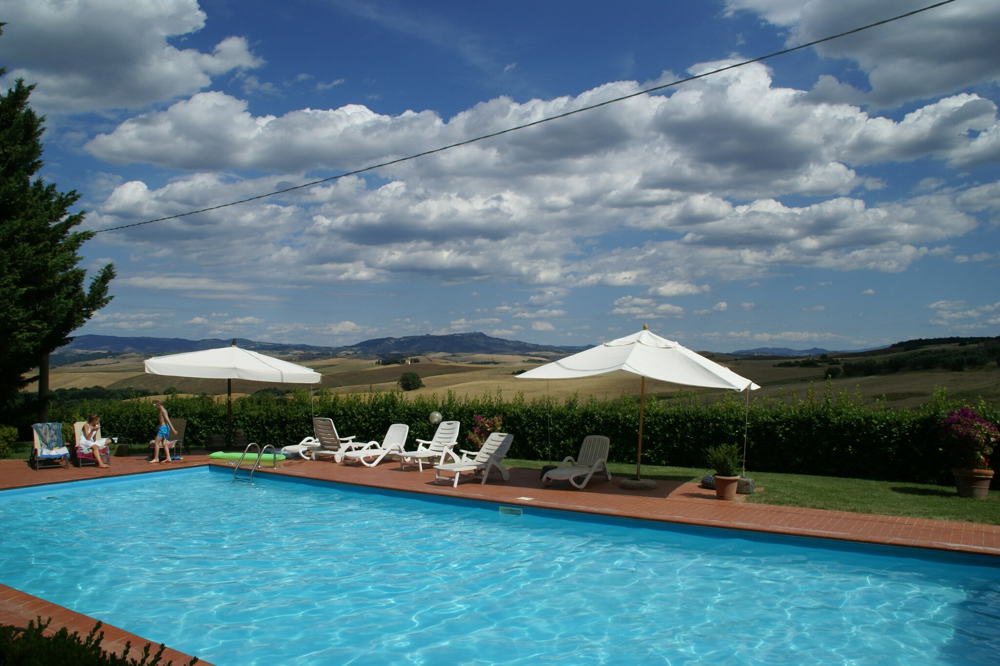 Nestled in the rolling landscapes of Orciatico, this charming holiday home offers an idyllic escape for travelers seeking relaxation. Surrounded by lush greenery, the property provides a peaceful stay with modern comforts while embracing authentic Tuscan charm. Guests can unwind in the countryside, enjoying moments of serenity or exploring nearby historic towns. Whether for a nature-filled retreat or cultural exploration, this home promises an enriching experience.

Designed for convenience, the home features an open kitchen equipped with a coffee machine, espresso machine, oven, dishwasher, and fridge-freezer. A cozy living area with a sofa bed and satellite TV ensures entertainment and relaxation, while a well-appointed bedroom and modern bathroom provide privacy and comfort. Guests can enjoy a shared relaxation space with a fireplace, a terrace with garden views, BBQ facilities, and a refreshing swimming pool (open Mayâ€“October). Additional amenities include bicycles, play equipment, and a hammock, adding to the leisure options.

Ideally located for cultural discovery, the home is close to Volterra (20 km), known for its medieval charm, and Tuscanyâ€™s most renowned cities, including Florence and Pisa. Just 45 km away, the Tuscan coast offers pristine beaches and vibrant seaside towns. Nearby restaurants serve classic Tuscan dishes, highlighting fresh, regional ingredients. Whether exploring historic villages, relaxing by the sea, or indulging in wine tastings, this retreat provides an unforgettable Tuscan experience.