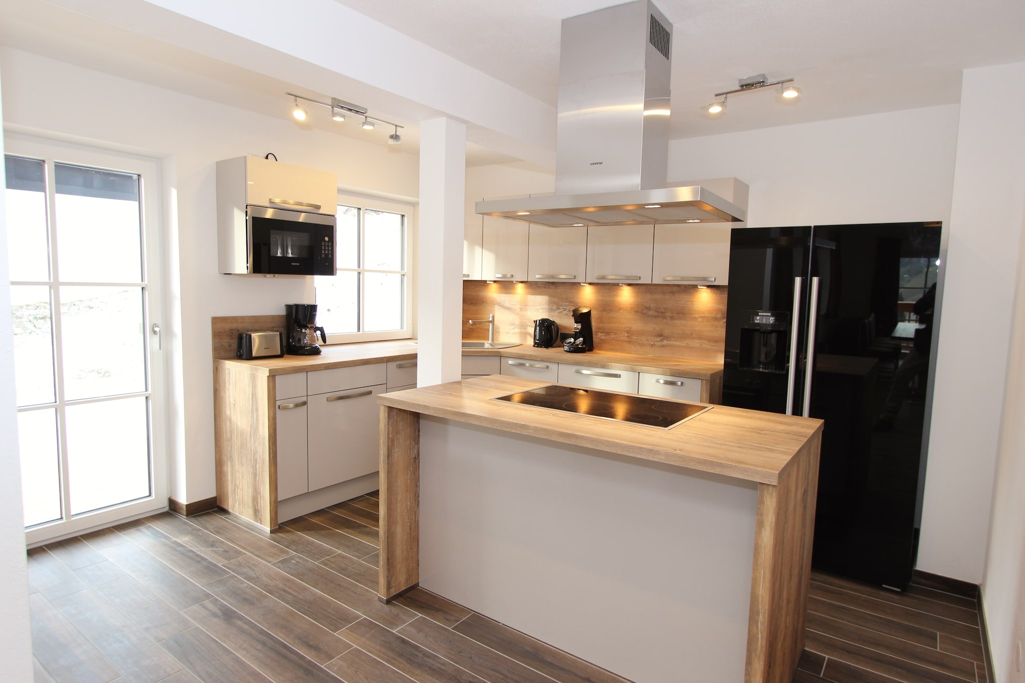 Ground floor: (hallway, storage)\n\nOn the 1st floor: (hallway, Living room(TV, balcony), dining room(TV, stove(wood)), open kitchen(cooker(ceramic), oven, microwave, dishwasher, fridge-freezer, terrace), bedroom(double bed, TV), bathroom(shower, 2x washbasin, toilet), toilet, toilet)\n\nOn the 2nd floor: (hallway, bedroom(double bed, TV, balcony), bedroom(double bed), Bedroom with bathroom(double bed, TV, shower, 2x washbasin, toilet), Bedroom with bathroom(double bed, TV, shower, washbasin, toilet, balcony), bathroom(bathtub with shower, 2x washbasin, toilet), relaxation area(shower, sauna, washbasin))\n\nski storage(ski boot heaters), heating(floor heating), garden, garden furniture, parking