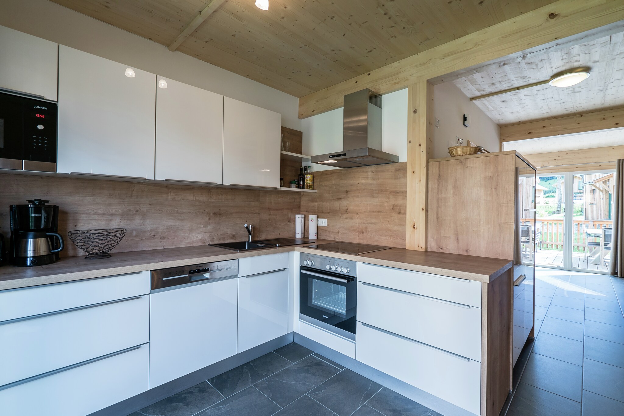 Ground floor: (hallway, Living room(TV(satellite), DVD player, radio, gas fireplace), open kitchen(electric kettle, toaster, cooker(ceramic), coffee machine(filter), oven, grill, microwave, dishwasher, fridge-freezer, dishes and cutlery(Bowls, chopsticks, plates, cups, etc.)), bathroom(shower, washbasin, toilet), Internet access)\n\nOn the 1st floor: (bedroom(double bed), bedroom(single bed, bunk bed), bedroom(double bed), bedroom(double bed), bathroom(hot tub, shower, washbasin, toilet), sauna, hairdryer)\n\nBubble bath, storage, ski boot heaters, heating(electric, central), terrace, garden, garden furniture, parking, children\'s bed, high chair, drying cabinet