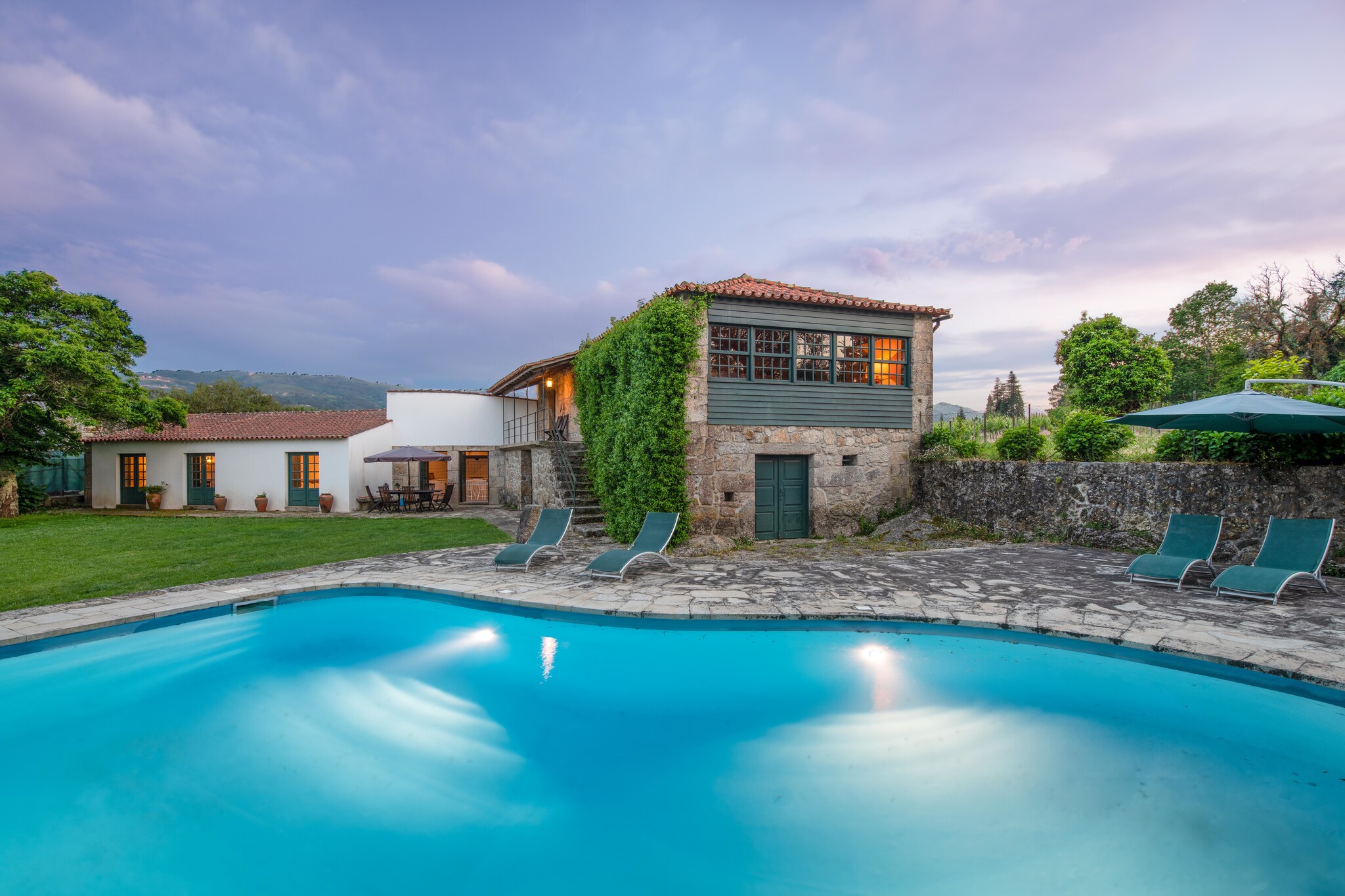 This 3-bedroom mansion, partly built of granite, in Ponte de Lima, is located in a wine estate and can house 6 people. Ideal for a large family, it features a private swimming pool, where you can take a few dips and a private garden, to relax. 
There is a river, 500 m away, where you can go for picnics. The town centre, 5 km away is the place to go, if you want buy, shop or eat. A day trip to the nearby sea, 35 km away can also be planned. 
The centrally-heated mansion has a private garden, if you want to enjoy the sunny day. There is barbecue facility, if you want to enjoy grilled delicacies. Fireplace in the living room keeps the indoors warm. A kitchen, well-equipped with cooking essentials, is also at your disposal. 
Nearest airport is 90 km away.