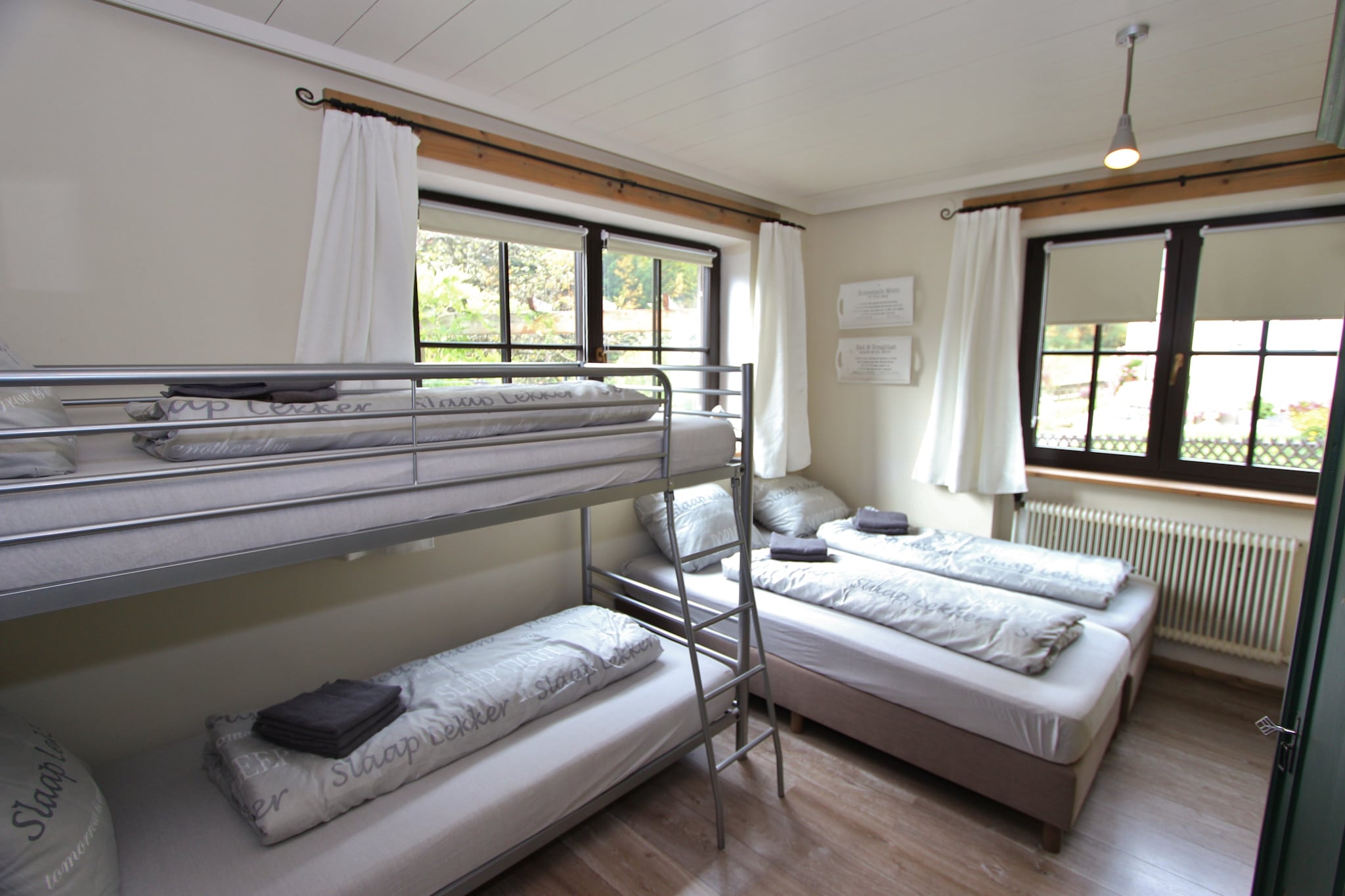 Ground floor: (Living room(double sofa bed, TV, stove(wood), stereo unit, terrace), open kitchen(cooker(ceramic), oven, microwave, fridge-freezer), bedroom(3x single bed), bedroom(2x single bed, bunk bed), bathroom(shower, 2x washbasin, toilet))\n\nOn the 1st floor: (hallway, Living room(double sofa bed, TV, stove), open kitchen(cooker(ceramic), oven, microwave, dishwasher, fridge-freezer), bedroom(2x single bed, bunk bed), bedroom(2x single bed), bathroom(bathtub with shower, 2x washbasin, toilet), balcony)\n\nBasement: (bedroom(double bed), bathroom(shower, washbasin), toilet)\n\nski storage, garden, garden furniture, parking