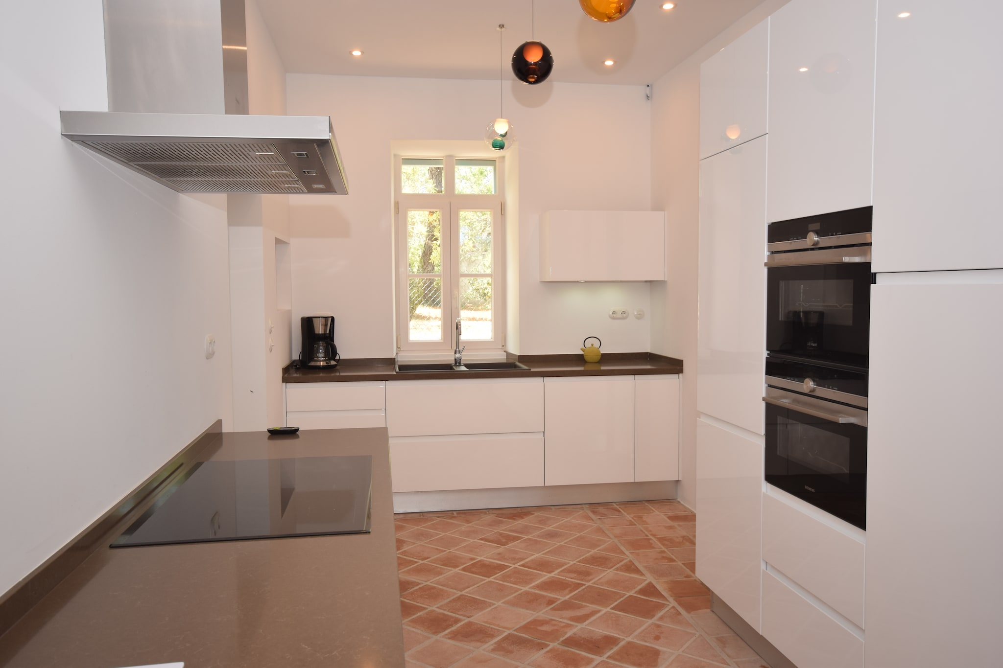 Ground floor: (hallway, Living room(stove(wood), seating area, heating(floor heating)), dining room(dining table(6 persons), heating(floor heating)), TV room(TV(satellite, international television channels), seating area, DVD player, stereo unit, heating(floor heating)), Kitchen(hob, coffee machine, oven, grill, combination microwave, dishwasher, fridge-freezer, heating(floor heating)), bathroom(shower, washbasin, toilet, heating(floor heating)), library, storage(washing machine, children\'s bed, high chair, playpen))\n\nOn the 1st floor: (bedroom(2x single bed, heating(floor heating), air conditioning), Bedroom with bathroom(double bed, shower, washbasin, toilet, heating(floor heating), air conditioning), Bedroom with bathroom(double bed, bath tub, shower, washbasin, toilet, balcony, heating(floor heating), air conditioning), bathroom(shower, washbasin, toilet, heating(floor heating)), roof terrace)\n\ncarport, microwave, dishwasher, bathtub or shower, patio, terrace, garden, garden furniture, sun loungers, BBQ(charcoal), deckchairs, parasol, swimming pool(shared with other guests, 10 x 5 m.), table tennis table, children\'s bed, high chair, ironing board, party games