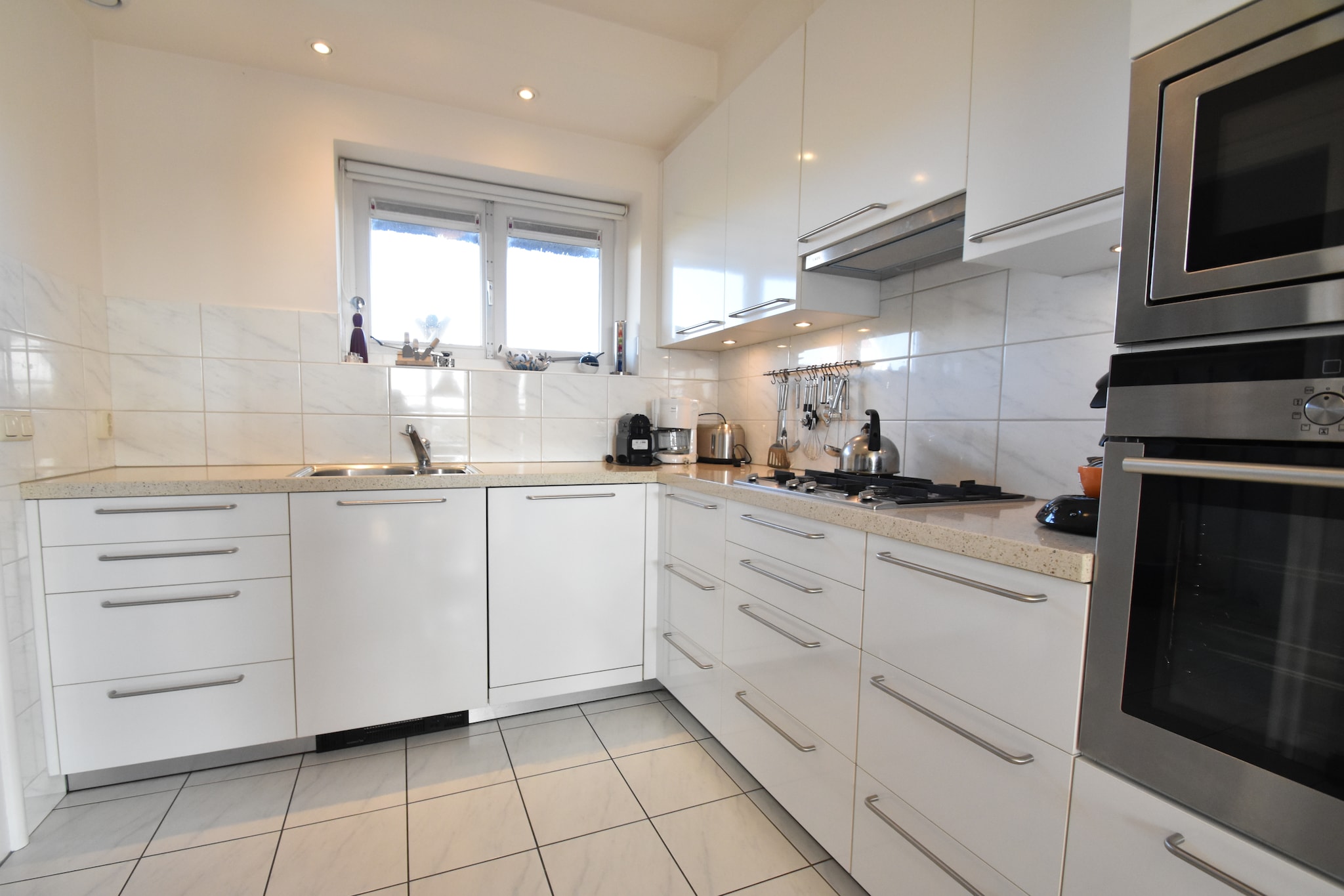 Ground floor: (open kitchen(cooker(gas), coffee machine(filter, pads), oven, microwave, dishwasher, fridge), Living/diningroom(TV, fireplace, DVD player, stereo unit), toilet)\n\nOn the 1st floor: (bedroom(2x single bed(duvet)), bedroom(2x single bed(duvet)), Bedroom with bathroom(double bed(twin duvet), TV, bath tub, shower, washbasin, toilet), bathroom(shower, washbasin, toilet))\n\nstorage(high chair), garage, tumble dryer, bathtub or shower, washing machine, heating(gas), terrace(private), garden(private, fenced), bicycle storage, garden furniture, parking, parasol, ironing board