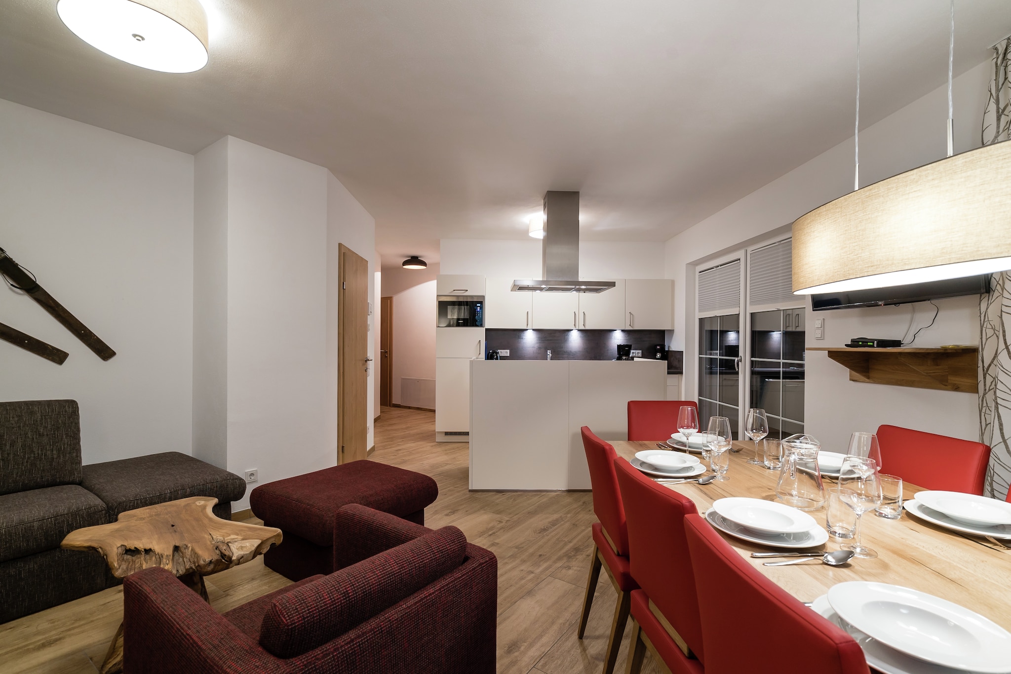 On the 1st floor: (hallway, Living room(TV, dining table, seating area, terrace), open kitchen(cooker, coffee machine, oven, dishwasher, fridge-freezer), bedroom(double bed, balcony), bedroom(2x bunk bed, balcony), bedroom(double bed, balcony), bathroom(shower, washbasin, toilet), bathroom(shower, washbasin, toilet), relaxation area(shared with other guests)(shower, sauna(paid), toilet))\n\nBasement: (washing room(tumble dryer(shared with other guests), washing machine(shared with other guests)), ski storage(ski boot heaters))\n\nheating(floor heating), terrace, parking, parking, lift, children\'s bed, high chair