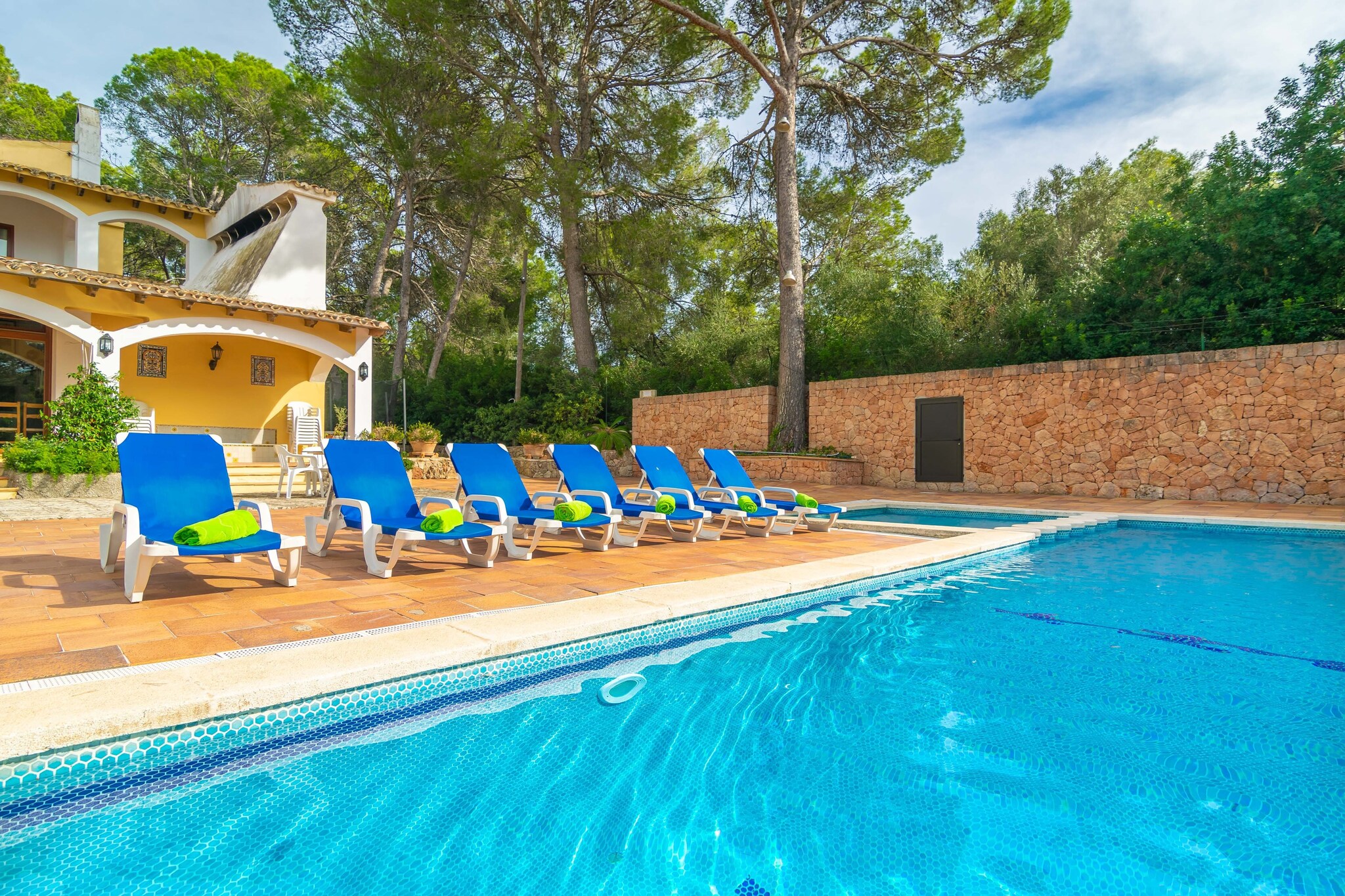 This estate has spectacular exteriors that include a large private chlorine swimming pool, -11 x 5m and 1.1 to 2.5m deep-, with an integrated children's pool, -3.5 x 3.5m and 0.5m deep-. Surrounding it there are 9 sun loungers and a large grassy area for sunbathing or playing with the little ones. Different garden areas, a lake with fish and several terraces and porches, including one with a barbecue, guarantee unforgettable moments. There is also a ping-pong table, a paddle tennis court and a basketball court, which can be accessed at any time.
This large manor house offers two floors. On entering the house, you find a large living-dining room with television, air conditioning, fireplace and exit to one of the porches. Then you have a kitchen, equipped with a gas cooker and a table to have an aperitif perhaps. Then there is a second kitchen with gas hob, a second huge dining room with access to the pool, another living room with a billiard table and a toilet. On the first floor there are 6 bedrooms with air conditioning and wardrobe and 5 bathrooms. 4 bedrooms offer double beds and the other 2 have two single beds. Three of them offer en-suite bathrooms, one with bath and shower, one with bath and one with shower. Then there are two more bathrooms, one with bathtub and one with shower which complete this floor. In addition, there are two more bathrooms with shower which are exterior. There is a laundry area with washing machine, iron and ironing board. The house has oil central heating.
The villa is located 5.9 km from Sant Jordi, close to the golf course Son Gual, and is very well communicated as it is next to the motorway Palma-Manacor. Being close to the airport you can hear the sound of planes flying over the island. Further towards the coast, you have all kinds of services such as bars, restaurants, supermarkets, etc. We recommend a visit to the capital, Palma, with its extraordinary Cathedral of La Seu and its picturesque old town. You can visit beautiful beaches such as Can Pastilla, Cala Blava or Es Trenc.
Within the same plot there is a second house inhabited by the maintenance staff of the finca.
The water from the cistern is not valid for consumption. Note: This accommodation is intended for families and guests over 25 years old who are looking for a peaceful stay. Bookings for parties or celebrations are not accepted. A copy of the identification document of all guests will be required to confirm the reservation. Consult the advertiser for possible charges. Pets are not allowed. The holding of events is forbidden. There is exterior parking for 2 cars.
Distances
Beach: 10.7 km - Cala Blava
Airport: 14.5 km - Son Sant Joan
Golf course: 5 km - Golf Son Gual
Town: 5.9 km - Sant Jordi
Train station: 15.8 km - Estació Intermodal de Palma
Bus stop: 4.1 km - Camí de Sant Jordi, Sant Jordi
Ferry: 20.4 km - Port de Palma
Hospital: 10.5 km - Hospital Son Llàtzer
Guests are kindly required to dispose of all rubbish and ensure the property is properly tidied before departure. Should this not be the case, a charge of €90 will be deducted from the security deposit. Tourist license: ETV/2339Single Rental Registry: ESFCTU000007015000054062000000000000000000000ET/23393There's a mandatory tourist tax in Balearic Islands, called Ecotasa. All guests, except people under 16 years, have to pay this tax. The amount varies between 0.55€/night and guest during the low season and 2.2€/night and guest during the high season .The tax is reduced by half from the 9th day for your stay. Homerti - Central de Reservas CR/33