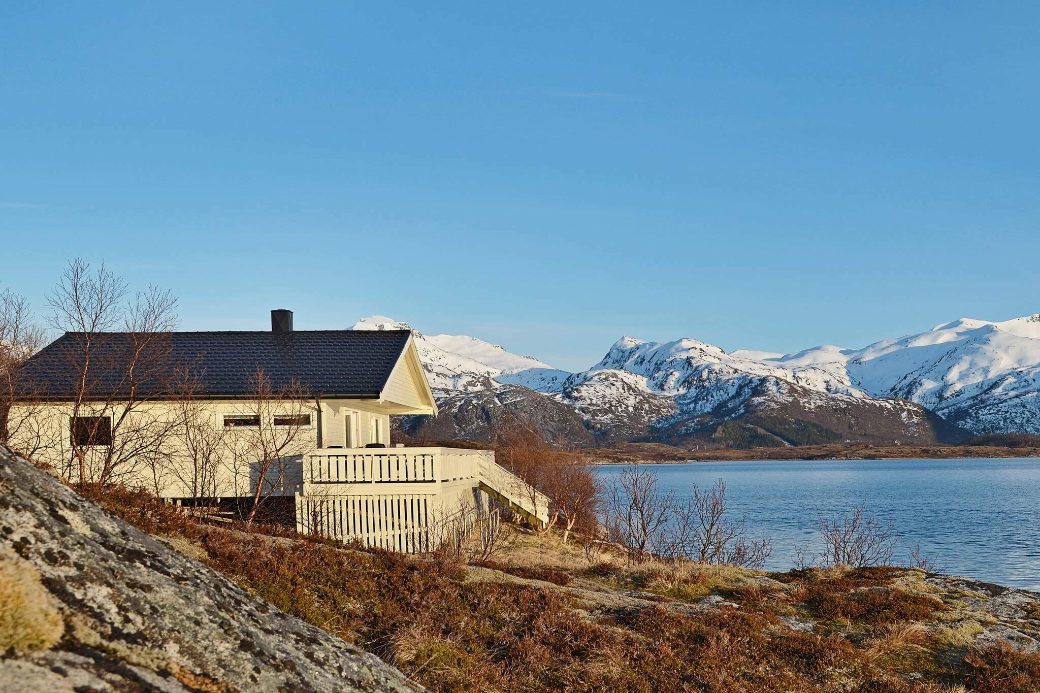This holiday cottage sits right on the water front by the small town of Sandsletta, on the west side of the island Austvågøya. The landscape is open and sunny and gives a panoramic view of the sea and the mountains. Enjoy sunsets from the terrace. It's especially delightful to sit on the rocks outside the cottage and listen to the waves hitting the beach. During bright spring and summer nights, the landscape will be colored red by the midnight sun. The shallow  bay below the house has a narrow stray where the sea water enters. You can catch both salmon and trout in this bay. A motor boat is included and is tied up right by the house. The area has several fishing lakes. The flat landscape is perfect for biking and hiking. 10 km to the foodstore in the fishing village Laukvik. Here you may also walk along the great pier protecting the harbor from stormy weather, and enjoy the fresh and salty sea air from the open ocean. On stormy days, the great weaves hitting the pier are impressive to look at. The town Sand further north has idyllic sandy beaches. The house is a perfect starting point for driving around Lofoten. 25 km to Svolvær, the centre of Lofoten with its shops, restaurants and airport. 30 km to Kabelvåg, where you can have a close up experience with live fish at the town's aquarium. A gallery and museum can also be found here. 17-21 ft boats is available for rent in Laukvik. BOAT ONLY AVAILABLE BETWEEN MAY 5TH AND SEPTEMBER 10TH.
