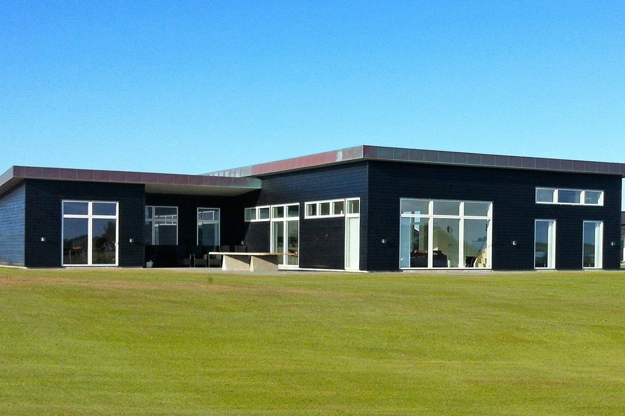 This unique and very spacious holiday home sets the standard with its building materials and high standard in quality. The style is minimalistic with a twist of the soul of the rigid nature surrounding the house. This is particularly obvious with the custom-made dining table in the kitchen area, built of hard oak planks. The oak has a clear contrast to the white, tasteful kitchen with e.g. two steam ovens, one combined microwave/cooker and induction with five cooking zones. The brick laid bar (with fridge) in the activity room is a natural place for gathering while a game of billiards, table tennis or table football takes place. Staircase from the activity room to one of the mezzanines with PlayStation for the kids. Furthermore you will find a wireless 30/30 Mbit internet (please bring your own computer). The pool area has slate walls and large, blue tiles in the pool. After a swim in the pool against the counter current you can relax in the sauna or enjoy the relaxing massage of the bobbles in the whirlpool. Direct access from the pool area to the terrace facing south-west and the garden, where you will find a large lawn with a basketball hoop and a trampoline (usage at own risk). Access to furnished terraces from both the kitchen and the living room, where you can enjoy the sun all day. All floors have Italian marble tiles. The unique floor planning and decor of the house makes it suitable for more families or couples who want to spend their holiday together surrounded by comfort. The house is located on a large plot near the holiday area Nr. Lyngby, a former fishing area. Due to the size of the house the price for final cleaning and deposit (DKK 5000,-) deviate from the normal listed price. Payment of consumption and cleaning must be paid in cash to the concierge at the house. No letting to youth and builder groups.