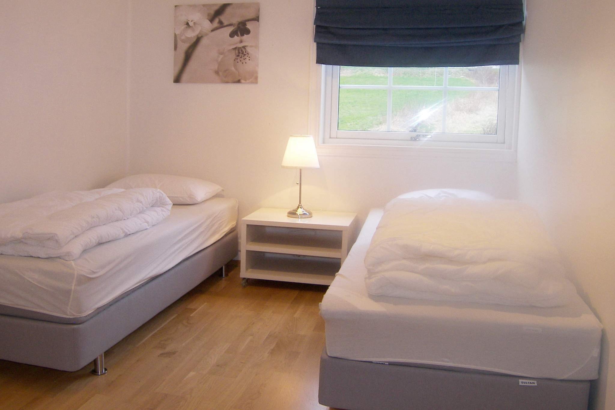 Great holiday apartment right by the fjord in Leikanger municipality. From the apartment on the second floor of a garage, you have a fantastic view of Sognefjorden. The house has a sheltered and covered balcony with walls on both sides. A small road goes between the house and the fjord, but with little traffic. This is a quiet and beautiful residential area. At your disposal is an idyllic yard that goes all the way down to a private, sandy beach with a dock, rowing boat, outdoors fireplace/grill and gazebo, where you can enjoy the scenic view in all kinds of weather. You can also rent a 25 hp outboard motor and borrow diving equipment and water skis. The single bedroom can be made into a double. Baby cot can be requested. The apartment was renovated in 2012, and all furniture and equipment is from this year. Either if you are sitting at the dining table, in the living room or on the balcony, you have a stunning panoramic view of the fjord. Leikanger is sunny with a mild climate. Here you can find fruit trees that usually does not grow this far north, like peach, apricot and walnut. If you visit at the right time, you can taste peach and fruit from the hostess' garden. In May, 80 000 fruit trees are in full bloom, an impressive sight. In September, plums, pears and apples are ripe. Leikanger is centrally located for all attractions by Sognefjorden. The express boat wharf is only a 5 minute walk from the house. Travel with the boat for day excursions to Flåm, Bergen or for island hopping by the coast.