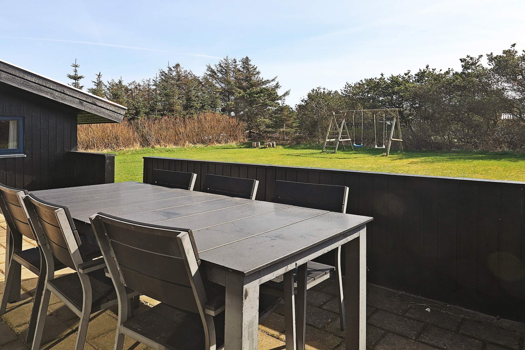 Internet Access DSL, open kitchen(cooker(electric), hood, coffee machine, dishwasher, fridge-freezer, washing machine), Living/bed room(TV(satellite, german television channels, danish TV channels (DR1 and TV2))), bedroom(double bed), bedroom(double bed), bedroom(2x bunk bed), bedroom(2x bunk bed), bathroom(floor heating)(bathtub or shower, washbasin, toilet), bathroom(floor heating)(bathtub or shower), Bubble bath(indoor, heated), sauna(indoor, heated), heating(electric), terrace, play equipment, air to air heatpump