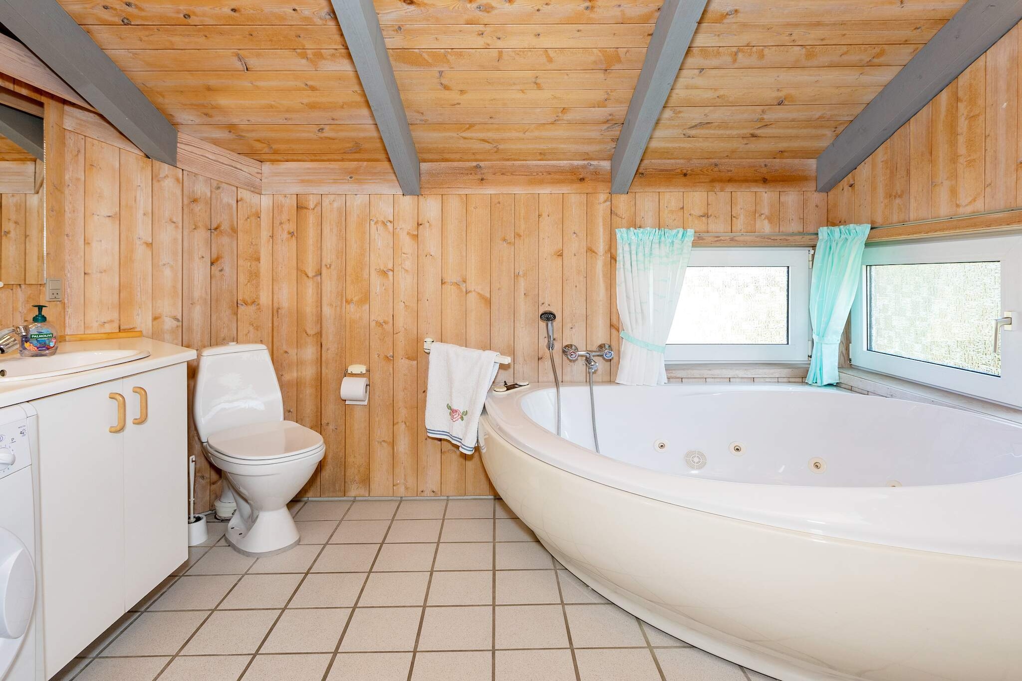 Tucked away on a beautiful natural plot surrounded by trees, this holiday home offers a peaceful retreat not far from the North Sea. The setting is ideal for those who love the outdoors, with fresh sea breezes and plenty of space to relax. Inside, the house combines comfort and functionality, making it a welcoming base for families or couples. The highlight of the bathroom is the whirlpool and sauna, inviting you to indulge in soothing moments of wellness after a day spent by the coast. The open-plan kitchen is well equipped and connects seamlessly to the living room, creating a cozy space for shared meals and relaxation. Here, you can enjoy the warmth of the wood-burning stove, listen to music on the stereo, or watch television with both German and Danish channels. From the living area, doors open directly onto the terrace, which is partially covered and perfect for quiet mornings with coffee or summer evenings outdoors. Practical details like underfloor heating in the kitchen and living room, as well as a washer-dryer combination, ensure year-round comfort and convenience. Beyond the house, there are many ways to enjoy your holiday. A nearby campsite offers a large water park with wellness facilities, perfect for family fun or an afternoon of relaxation. The bustling town of Fjerritslev lies close by, with shops and restaurants to explore. And down at the beach, you can even buy freshly caught fish straight from the local fishermen. Whether you seek nature, relaxation, or authentic local experiences, this holiday home places it all within easy reach.