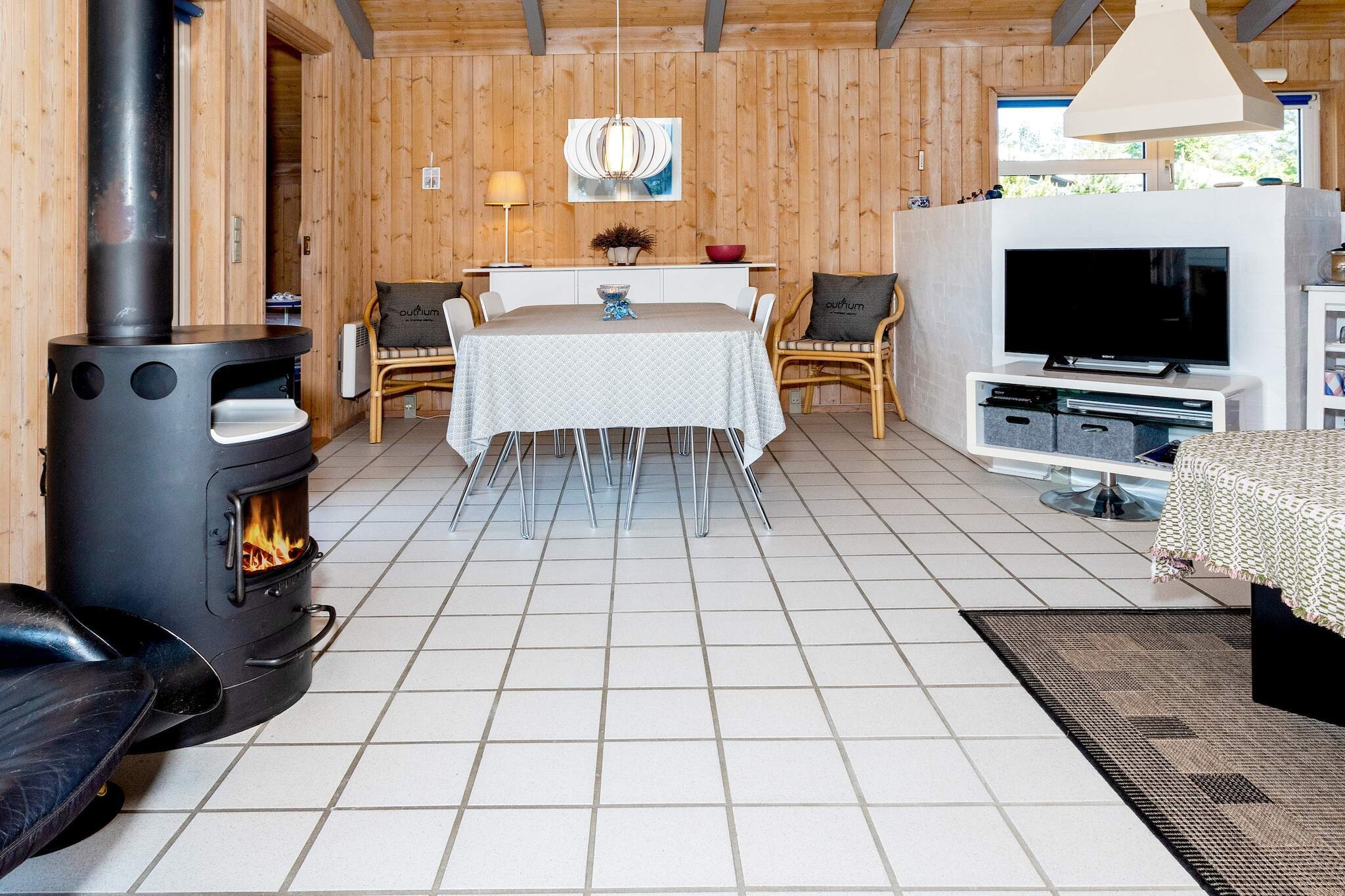 open kitchen(cooker(electric), hood, coffee machine, microwave, dishwasher, fridge(+ freezer), tumble dryer, washing machine), Living/bed room(TV(satellite, german television channels, danish TV channels (DR1 and TV2)), CD player, stereo unit, high chair), bedroom(double bed, children\'s bed), bedroom(double bed), bedroom(2x single bed), bathroom(floor heating)(bathtub or shower, washbasin, toilet), mezzanine(2x single folding bed), Bubble bath(indoor, 2 persons), sauna(indoor, heated, 4 persons), heating(electric), terrace, play equipment