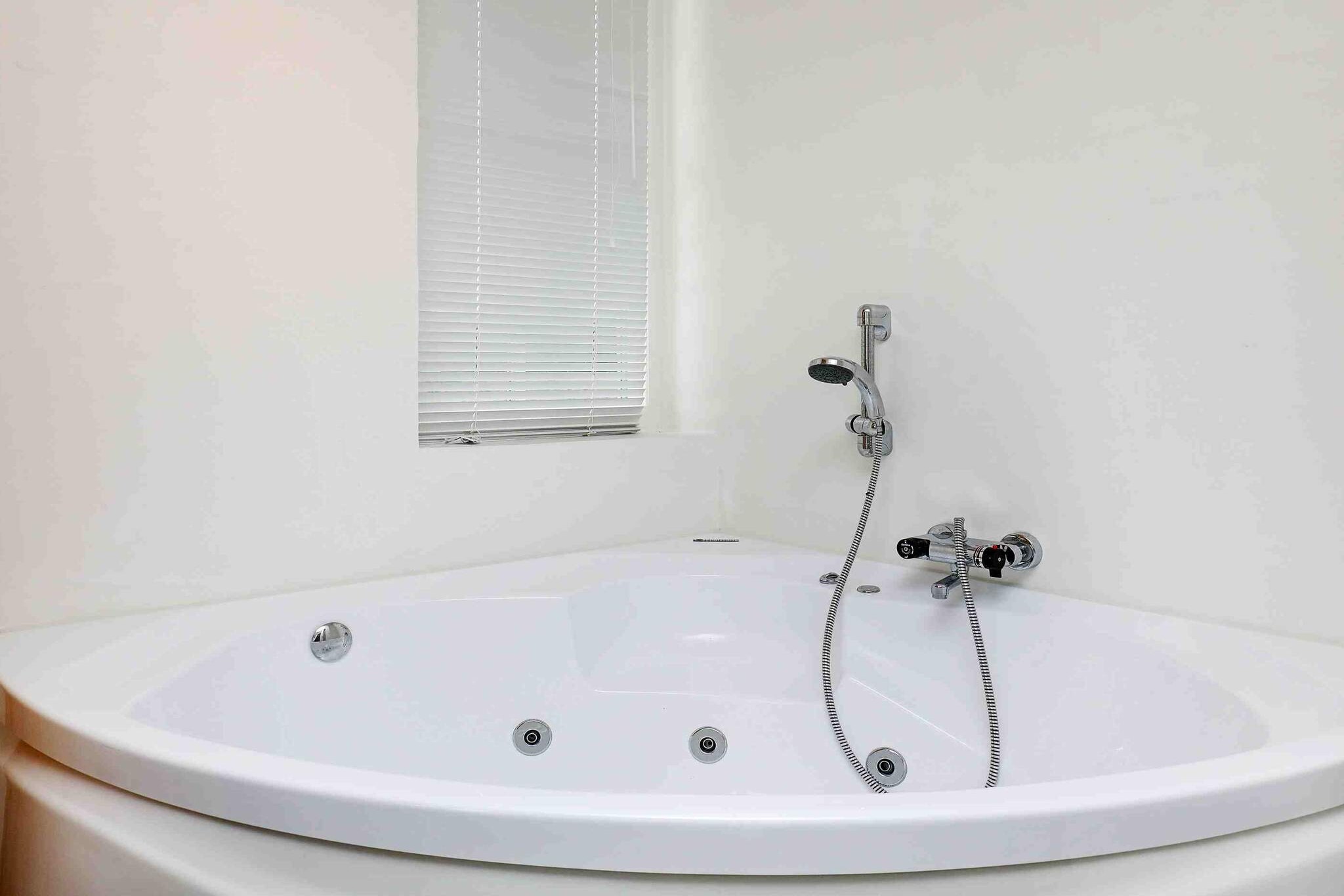 Annex: (2x bunk bed)\n\nopen kitchen(cooker(electric), hood, coffee machine, dishwasher, fridge-freezer, washing machine), Living/bed room(TV(satellite, german television channels), CD player, stereo unit, chromecast), bedroom(double bed), bedroom(double bed), bedroom(2x single bed), bathroom(floor heating)(bathtub or shower, washbasin, toilet), bathroom(bathtub or shower, washbasin, toilet), Bubble bath(indoor, 2 persons), sauna(indoor, heated, 2 persons), heating(electric), terrace, terrace(roofed), BBQ, air to air heatpump