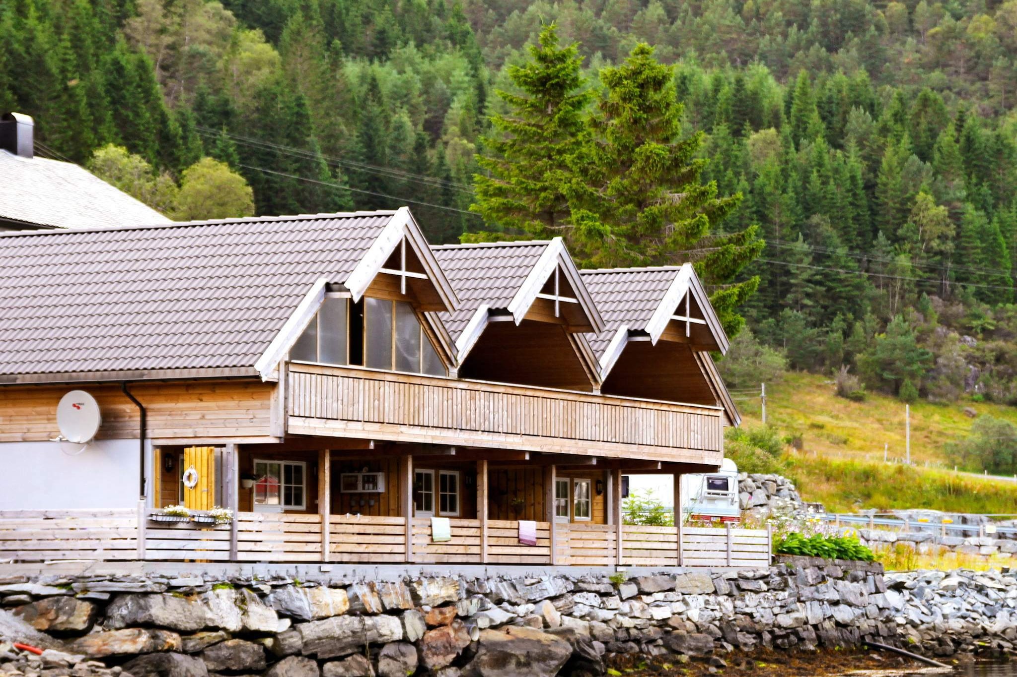 This holiday house sits on the waterfront in Hyllestad municipality. Seen from the sea, the house is to the far right. Hyllestad can offer you rich nature experiences with wilderness, coast, valleys and mountains. The sea has excellent fishing conditions, especially during spring and autumn, but also the rest of the year. The cabin is suited for max 4 adults and 2 children up til 12 years old. You can actually sit on the veranda and put the fishing line in the water and wait for a bite. Both terraces are covered and from the ground floor you can enter the terrace from two of the bedrooms. The house is well equipped and all of ground floor has underfloor heating. Two of the bedrooms have 90 cm wide beds that can be combined. The third has a 150 cm wide bed. Go for mountain hikes with magnificent views of the sea. You can also bike along the old postal road that stretches 40 km between Leirvik and Dale, and has some impressive stone bridges. Go on day excursions to the many sights and attractions nearby. You can go island hopping along the coast. Bergen is about 2,5 hours away by car. There are boats available, please check the booking page.