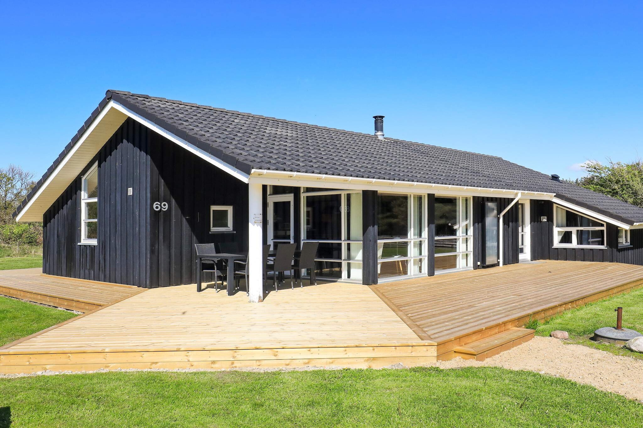 Spacious holiday cottage with 2 bathrooms of which one has whirlpool and sauna. The house is located at the wide Grønhøj Strand on a natural plot in scenic and secluded surroundings. Open concept kitchen and living room with exit to the terrace, 4 bedrooms and 2 bathrooms. Furnished in typical Danish style with modern and tasteful furnishings and large window sections facing south which provide great lighting and a comfortable atmosphere. There is a wood-burning stove for cosy evenings as well as cheap heating. All tile floors have underfloor heating. Both open and covered terrace. The house is located at the end of a large natural plot surrounded by plantings. There is a sandpit for the small children. No letting to youth groups. A refundable deposit might be charged closer to your check-in date. The security deposit ensures a smooth stay and covers any additional services or consumption charges.This deposit covers utilities consumed during your stay and any additional services that may be taken.The final amount will be adjusted based on actual meter readings, actual usage of extra services, and any remaining balance will be refunded within 21 days after checkout.This deposit simply acts as a prepayment for charges that  you would anyways pay for, ensuring a seamless stay and check-out experience.