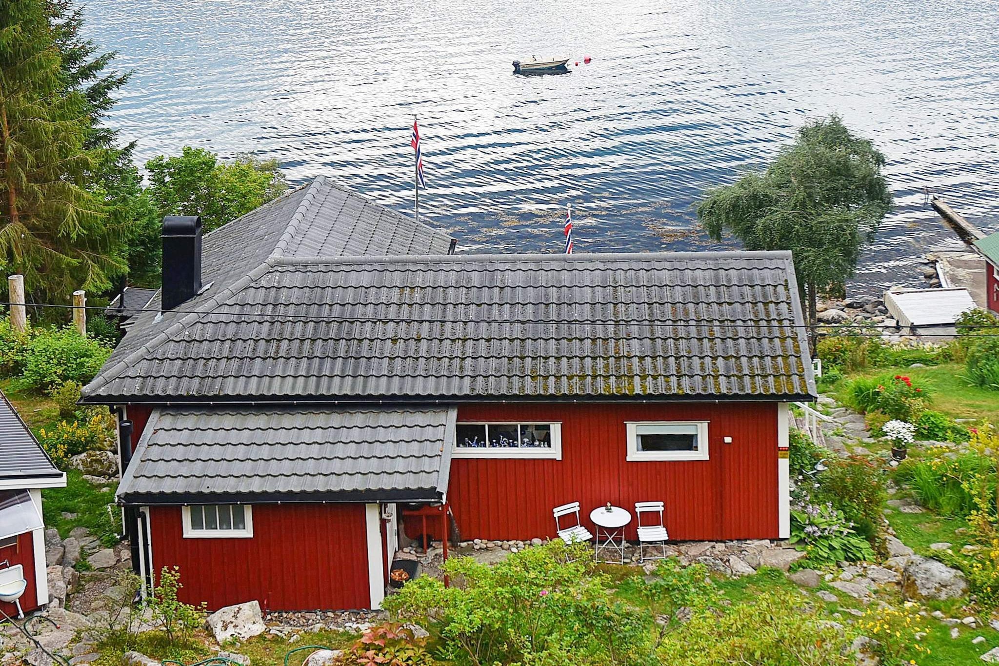 Enjoy a relaxing holiday 5 km west of Molde, "the city of the roses".  From the holiday cottage you have a panoramic view of mountains and the  sea. The cottage has a charming and traditional interior. It  faces south and is located in a peaceful environment on a slightly  slanting natural plot. The exterior was partly renovated in 2015 and the  annex is new. There are hundreds of European channels via Astra1.  You can also use the internet to stream TV. There is an electric  barbecue that you can use on the 13,5 m2 large terrace. Go  swimming in the fjord 50 metres away or on the beach 2 km away. There  are several hiking trails nearby that take you to the mountains. There  is a football goal 70 metres away, where you can unload your luggage at  arrival. 50 metres below the cottage there is a boat house  with a 14 ft boat and a Tohatsu 9,9 -> 1 hp motor, including life  vests. There is also a fish cleaning table with running water and  lights. The cottage is not far from the fjord, a good fjord for fishing.  There is trout and salmon in the river or lake 30 km away. Several  lakes in the mountains. Because of the steep terrain from the  parking lot to the cottage and boat house, this cottage is best  suitable for people in good shape. The parking space and access to  washing machine is nearby the owner, 125 metres away. The house owner's  son has a cottage 25 metres below your house, he is there some weekends.  The double bed is 120 cm wide. There is an incineration toilet (scent free) in the cottage,  while the shower is found in the annex, 2 metres from the main house. NB! Remember to bring cash to pay the deposit and boat. You can also pay the boat rent in Euro.