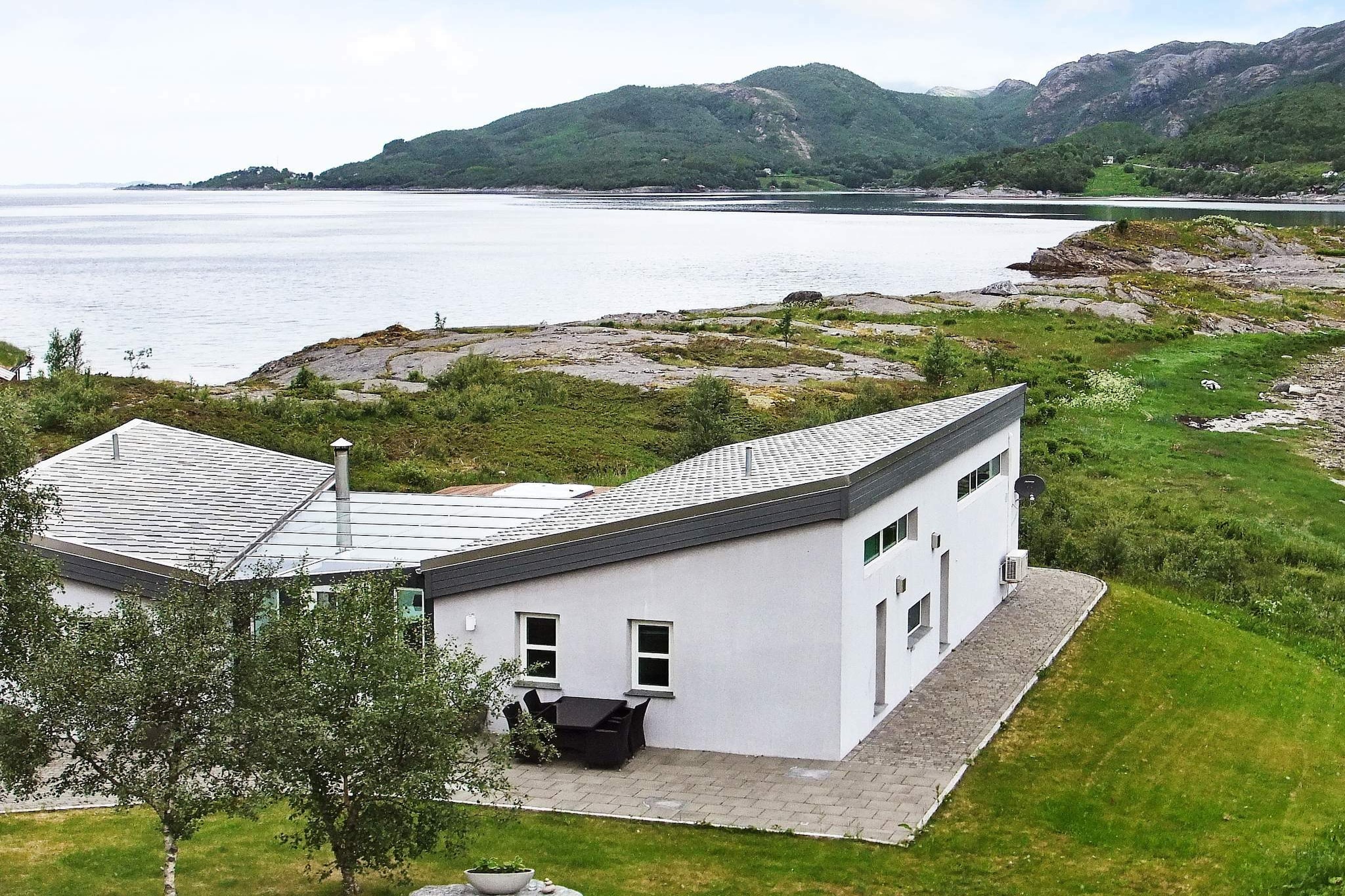 If you are looking for a comfortable holiday cottage by the sea, with a stunning scenic view, then this is the perfect choice. The house is situated right by the waterfront, 7 km south of the village Inndyr and 30 meters from the cottage 67508. The municipality Gildeskål is known for its beautiful, coastal scenery. Through the large windows in the living room, facing the sea and the beach, you will feel in touch with nature. This is especially true in spring- and summer nights, when it is just as bright as during the day with the midnight sun. Also in winter when the nights are long and dark, and the Northern Light is colourfully moving across the sky, this area is a great place to experience. The holiday cottage is spacious and practically furnished, with heated floors in all rooms except bedrooms. Satellite dish with many international channels, e.g. several German. The house has a unique layout, consisting of two units connected through a winter garden. In the smallest unit, there is a bathroom and two bedrooms, where one is also a living room with couch and TV. It is thus perfect for a larger group or 2 families traveling together. On cold days or stormy days, the winter garden, is a sheltered and comfortable place to gather. Here you can stay warm by the big fireplace. On the large terrace outside, there is a built-in whirlpool facing the sea. Here you can sit and enjoy the view and the fresh, salty sea breeze. The yard and the shallow water below the house is perfect for children, and from the house and terrace you can watch them play. The area has many holiday cottages, but this house is still secluded. 500 meters to a cafe and kiosk that has a limited selection of groceries. 1 boat for rent: 1 x 18 foot HR 532CC, 100 HP Suzuki engine, sounder, GPS and chartplotters. On request: If you want 2 boats, the owner can hire a 20-foot Stigfjord with 90 HP Suzuki with sonar and chart plotter for NOK 9000 per week (+ deposit NOK 3500). The boats are moored at the floating jetty in the marina 150 m from the holiday home. A bench for preparing fish is at your disposal. The area has several fishing lakes and lovely hiking trails for everyone in the family. A great starting point for road trips to e.g. Svartisen Glacier. 90 km to Bodø, a city with many shops and tourist attractions. There are several direct flights between Bodø and Oslo every day and rental cars are available at the airport. Smoking is permitted in the winter garden. Price per set towels: NOK 50 (one small and one large towel).