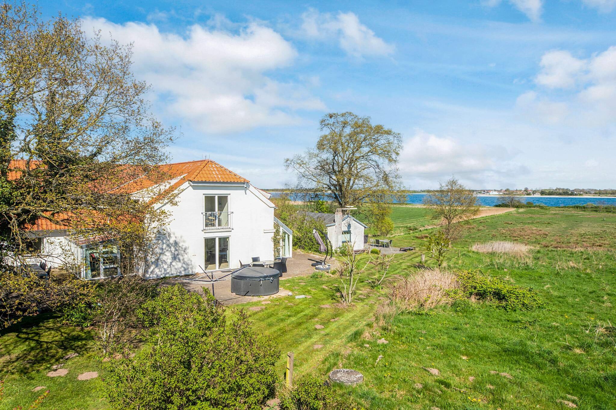 A holiday cottage right by the Little Belt. Enjoy the panoramic view from the outdoor whirlpool or terrace. On cooler days you can stay indoors and use the steam whirlpool and infra-red sauna. The sunrise can be seen from all rooms in the house except from one room. Five bedrooms has a panoramic view of the sea. One bedroom has a large balcony from where you can soak up the view even more. Another bedroom has a French balcony with a double door. The closest neighbours are units 13414 and 78277. The surroundings can be enjoyed at all seasons. Have a relaxing holiday stay with plenty of fresh air. There is a private pathway leading down to the beach. There is a trampoline (usage at own risk/insurance). You can book a boat for fishing, ask the local office. No letting to youth groups.A refundable deposit might be charged closer to your check-in date. The security deposit ensures a smooth stay and covers any additional services or consumption charges.This deposit covers utilities consumed during your stay and any additional services that may be taken.The final amount will be adjusted based on actual meter readings, actual usage of extra services, and any remaining balance will be refunded within 21 days after checkout.This deposit simply acts as a prepayment for charges that  you would anyways pay for, ensuring a seamless stay and check-out experience.