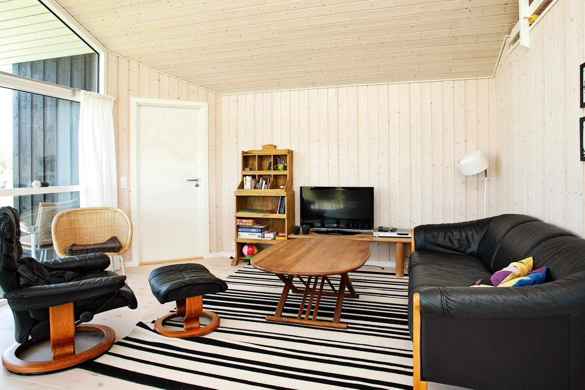 Bright and well-furnished holiday cottage at Grønhøj Strand. There is open concept living room and kitchen, 3 bedrooms, mezzanine and a bathroom with underfloor heating. Open terrace surrounding the house as well as a small, covered west-faced terrace. There is a air-to-air heat pump which helps make the energy costs low. Due to the large window sections the house is very bright in a typical Danish cottage style. The terrace has direct access to the level plot where you can play ball and there is a small fireplace as well as a swing set. The plot is an open natural plot. No letting to youth groups. A refundable deposit might be charged closer to your check-in date. The security deposit ensures a smooth stay and covers any additional services or consumption charges.This deposit covers utilities consumed during your stay and any additional services that may be taken.The final amount will be adjusted based on actual meter readings, actual usage of extra services, and any remaining balance will be refunded within 21 days after checkout.This deposit simply acts as a prepayment for charges that  you would anyways pay for, ensuring a seamless stay and check-out experience.