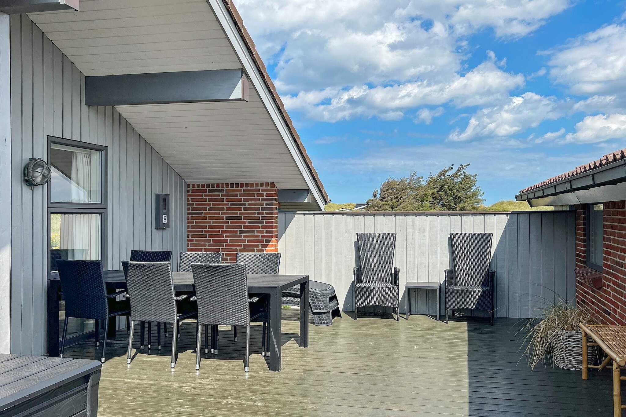 Annex: (2x single bed, washbasin, toilet)\n\nopen kitchen(cooker(electric), hood, coffee machine, microwave, dishwasher, fridge-freezer, washing machine), Living/bed room(TV(satellite, german television channels, danish TV channels (DR1 and TV2))), bedroom(double bed), bedroom(2x single bed), bedroom(single bed), bathroom(bathtub or shower, washbasin, toilet), mezzanine(2x single folding bed), game computer, game computer, heating(electric), terrace, BBQ, play equipment, air to air heatpump