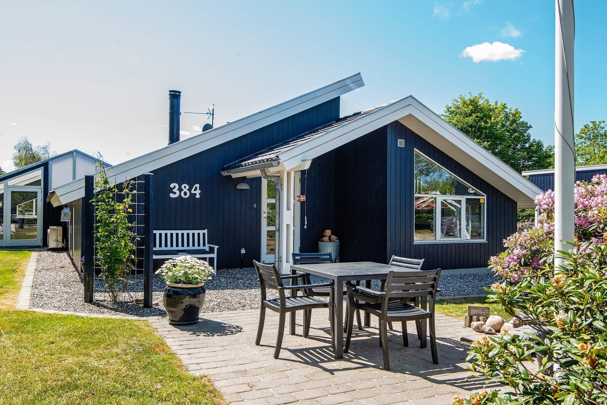 A modern and bright holiday home with a high-beamed ceiling, located on a well-manicured and secluded plot at the end of a quiet road. 150 metres to the fjord. The house is allergy-friendly with tiled floors. Separated living room and dining room, the latter with large windows and a view of the lovely garden. The centre of the house is the well-equipped kitchen. Solar panels and the heat pump ensures a low energy consumption. There is plenty of space for children to run around and play in the well-manicured garden. House and garden is architect designed. A large forest with a playground can be found nearby. There is a farmer's grocer only 100 metres away.A refundable deposit might be charged closer to your check-in date. The security deposit ensures a smooth stay and covers any additional services or consumption charges.This deposit covers utilities consumed during your stay and any additional services that may be taken.The final amount will be adjusted based on actual meter readings, actual usage of extra services, and any remaining balance will be refunded within 21 days after checkout.This deposit simply acts as a prepayment for charges that  you would anyways pay for, ensuring a seamless stay and check-out experience.