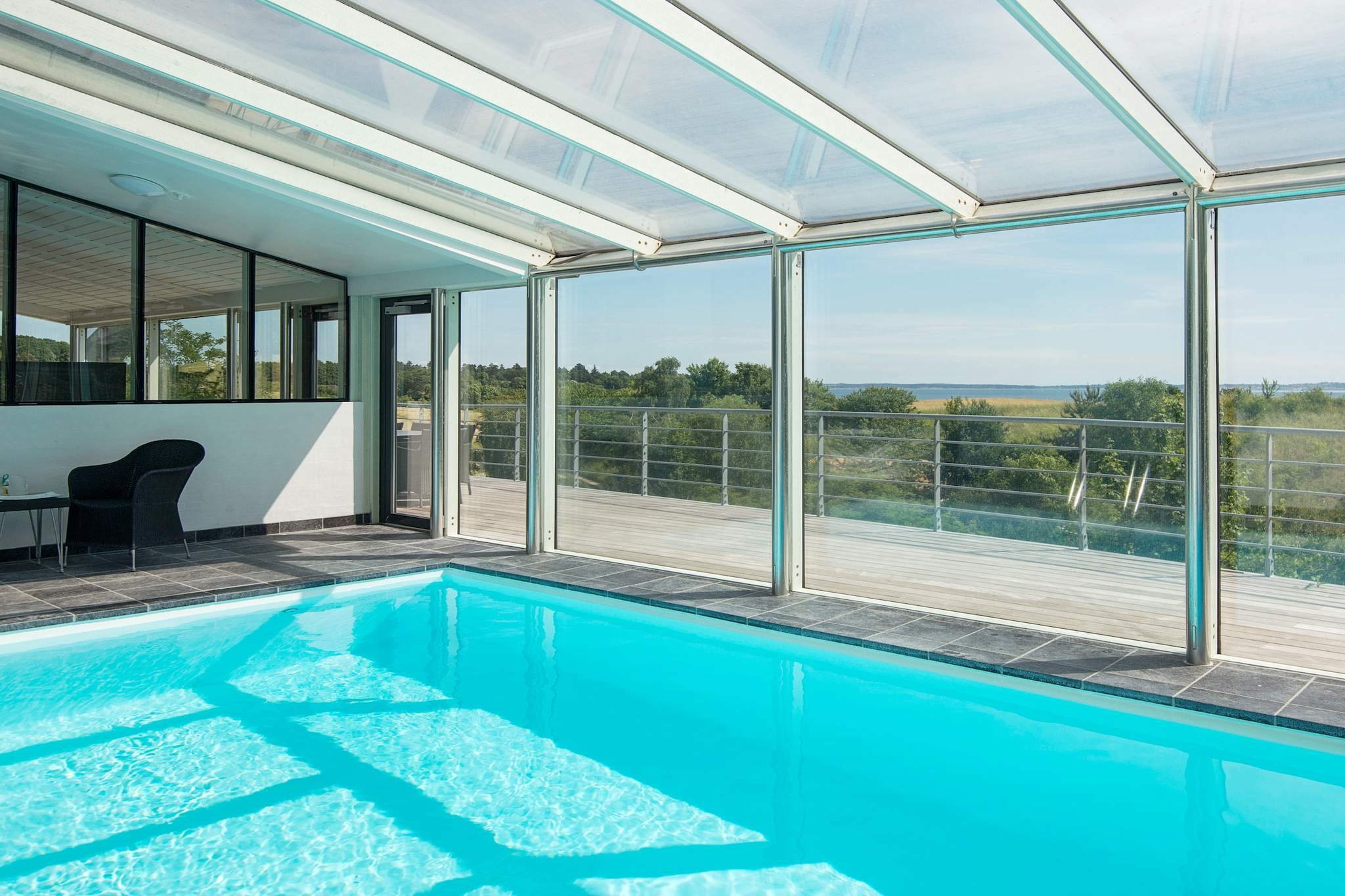 This holiday cottage is located approx. 200 m from a beautiful beach with direct trail right next to Mols Bjerge with a magnificent and unspoilt nature and a fantastic wildlife right outside the windows. On the beach below the house there is a diving course, which can be used free of charge. The house is not wheelchair accessible due to stairs and slopes. No letting to youth groups. The house has in 2008 undergone a total renovation where, by an exciting architectural solution "nature has been drawn into the house", so you can enjoy views of the hills of Mols, Ebeltoft Vig with Ebeltoft in the background from the living room, the kitchen or while you relax in the whirlpool or swimming pool. The house is bright and spacious throughout with skylights and high vaulted ceiling. The architecture and decor is minimalist. The house has tile and wood flooring and air-to-air heat pump. The kitchen is brand new from 2021 with its exciting design and central location, the natural point to gather for cooking. There is dishwasher, American fridge and microwave oven. There are large flat screen TV with Viasat access and two mezzanines where children can play. Bright rooms with good closet space. The pool area has a large pool and a corner whirlpool, and from here you can also enjoy the stunning views from both the whirlpool and pool. The terrace of 180 m² was built in teak with many good areas for enjoying the view.A refundable deposit might be charged closer to your check-in date. The security deposit ensures a smooth stay and covers any additional services or consumption charges.This deposit covers utilities consumed during your stay and any additional services that may be taken.The final amount will be adjusted based on actual meter readings, actual usage of extra services, and any remaining balance will be refunded within 21 days after checkout.This deposit simply acts as a prepayment for charges that  you would anyways pay for, ensuring a seamless stay and check-out experience.
